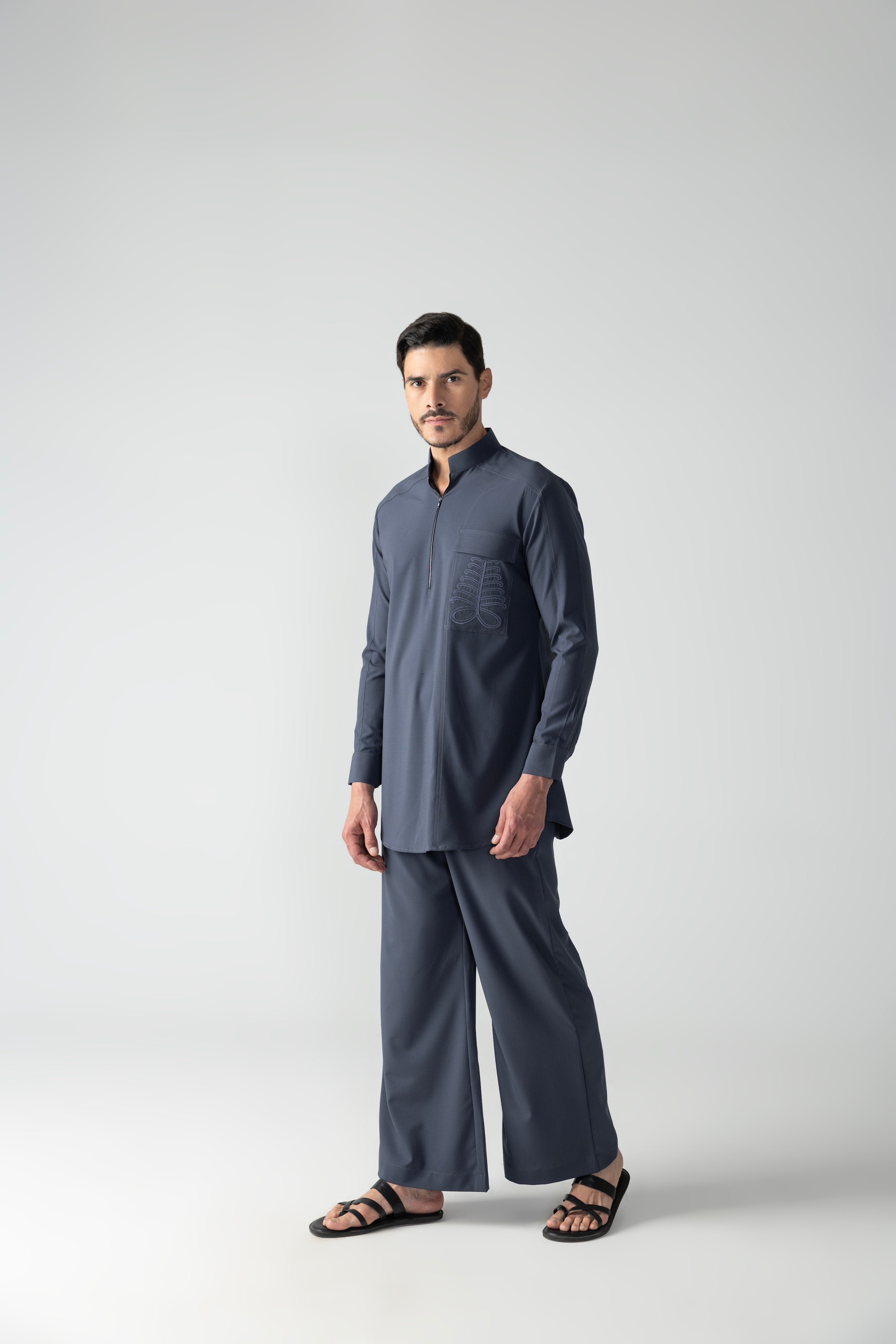 Dark grey short crepe kurta with embroidered patch pocket & zipper detailing, paired with a matching plazzo