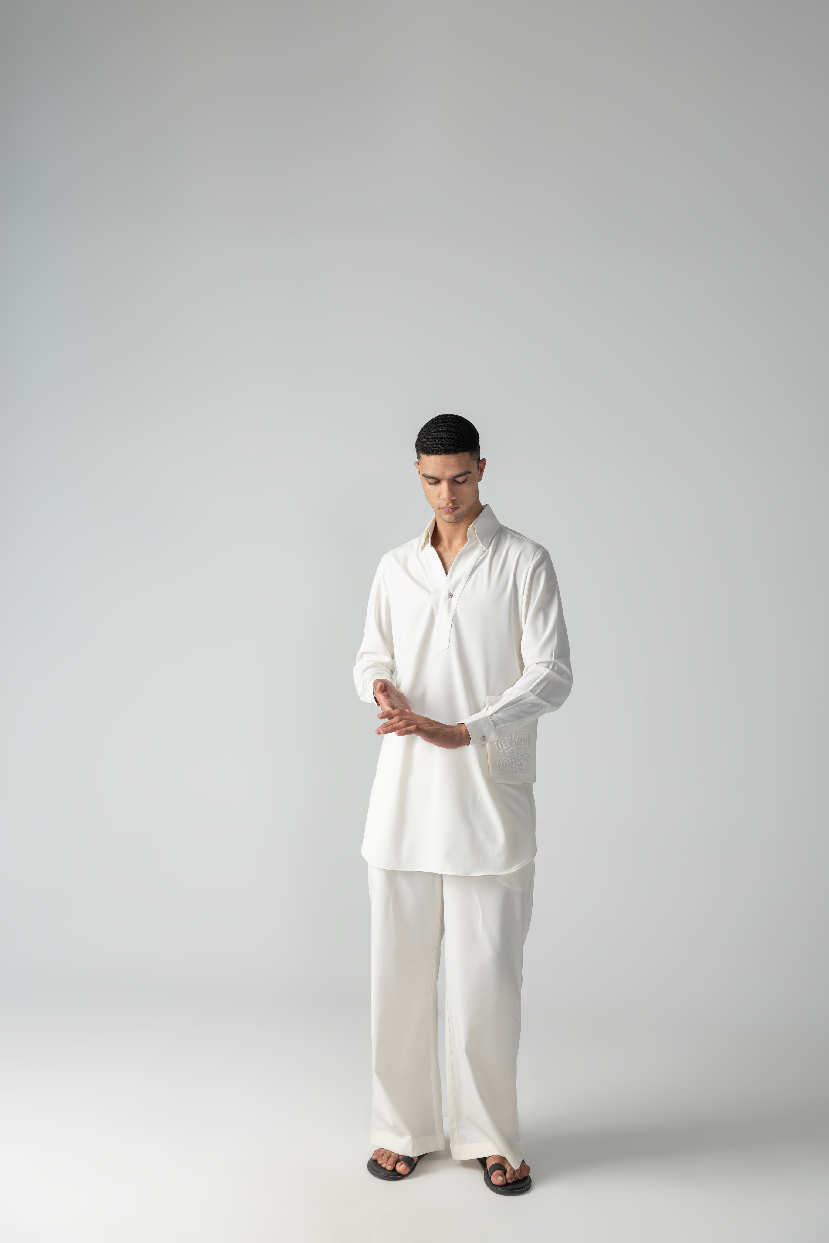 Ivory short crepe kurta with embroidered patch pocket detailing, paired with a matching plazzo