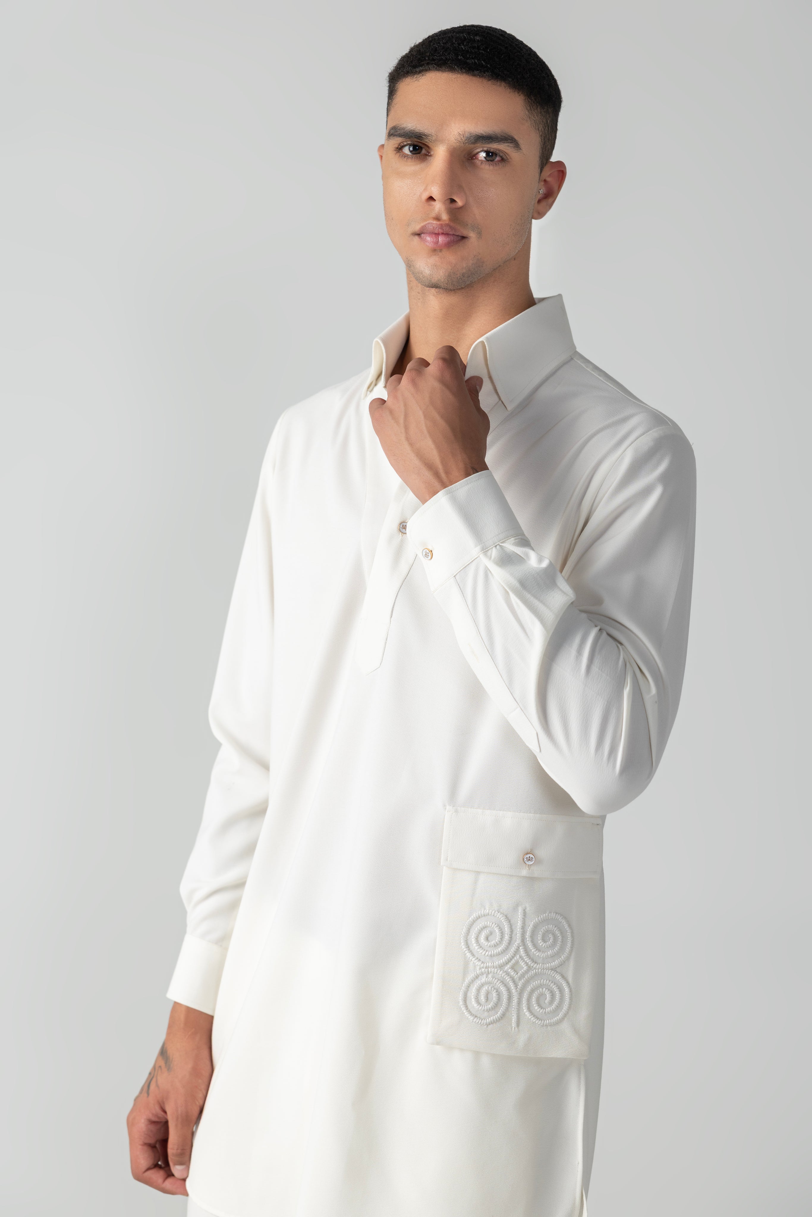 Ivory short crepe kurta with embroidered patch pocket detailing, paired with a matching plazzo