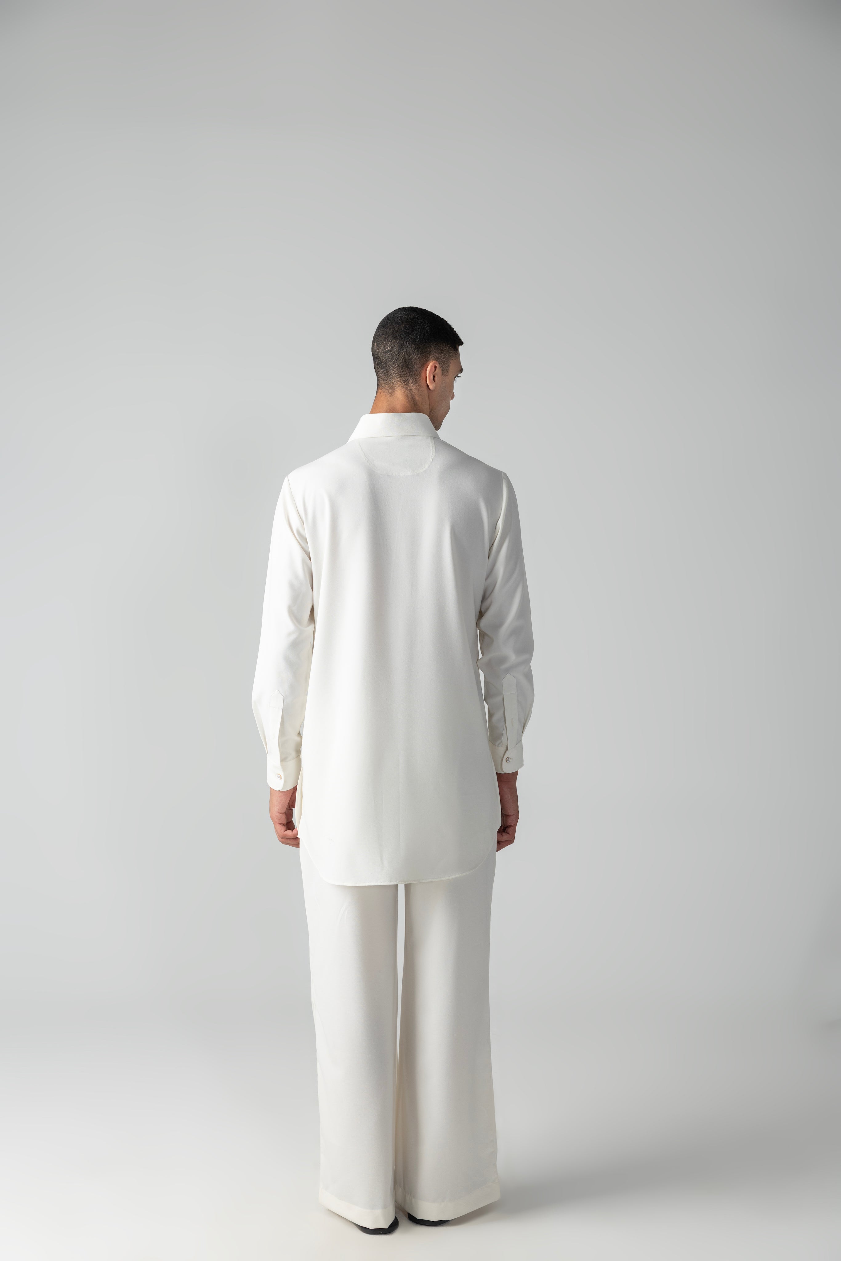 Ivory short crepe kurta with embroidered patch pocket detailing, paired with a matching plazzo
