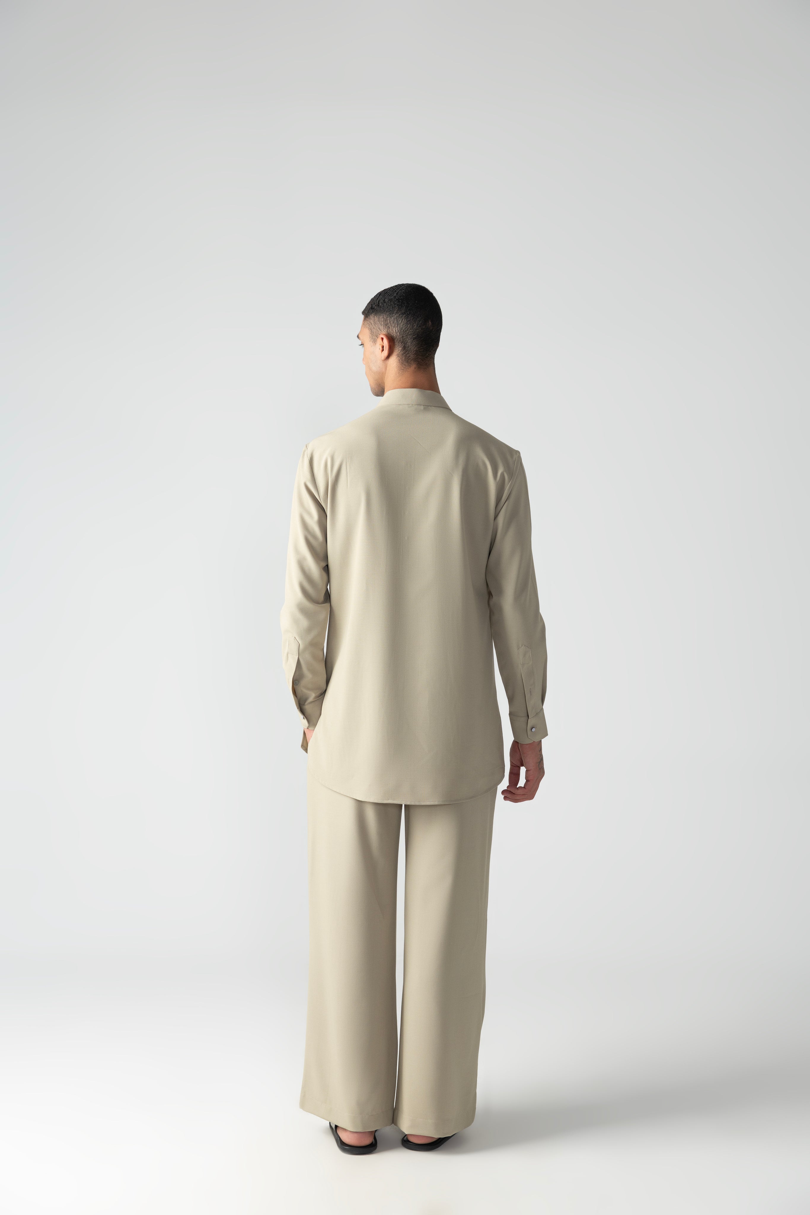 Beige short crepe kurta with patch pocket & thread embroidery detailing, paired with a matching plazzo.