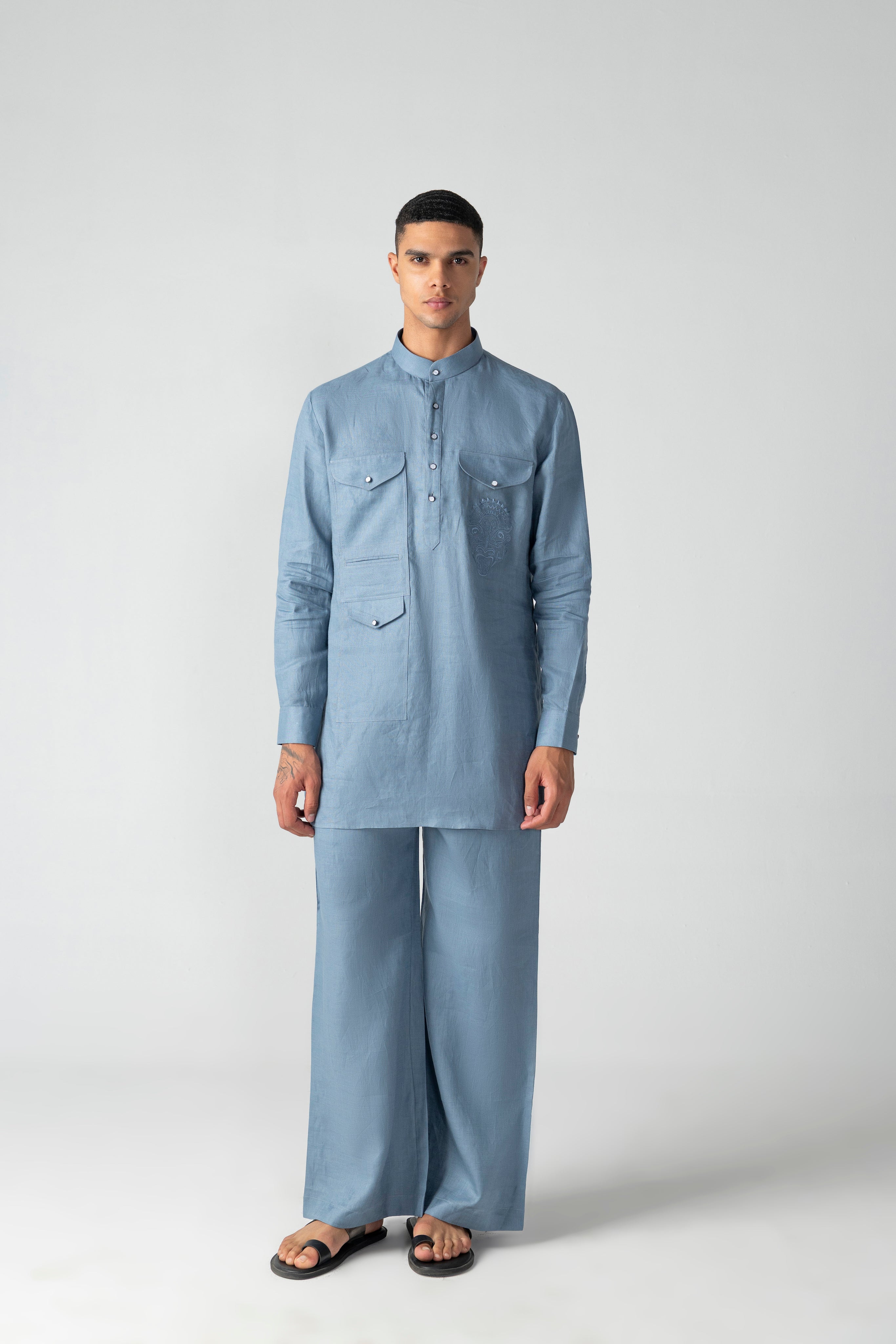 Navy blue linen short kurta with patch pocket & thread embroidery detailing, paired with a matching plazzo