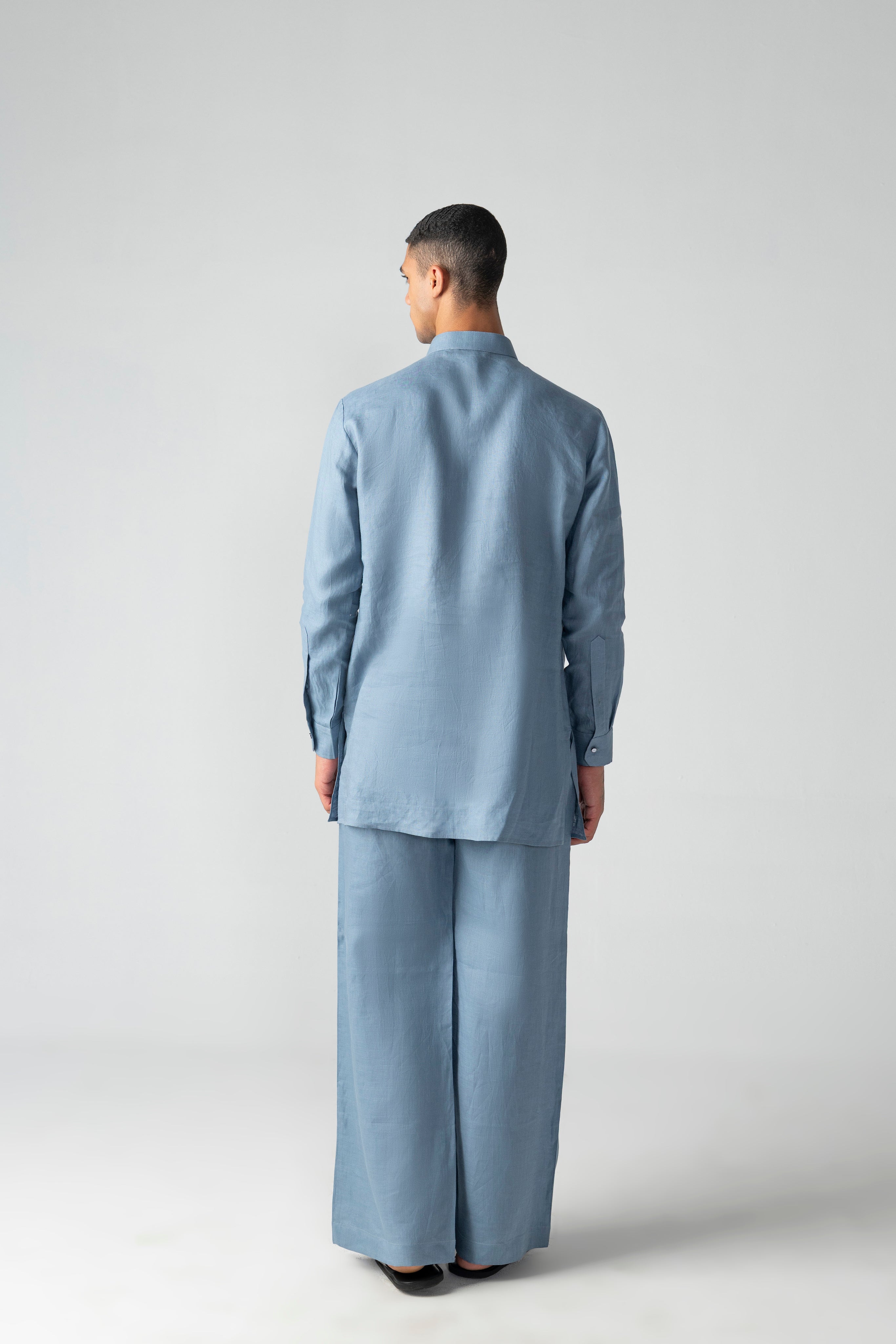 Navy blue linen short kurta with patch pocket & thread embroidery detailing, paired with a matching plazzo