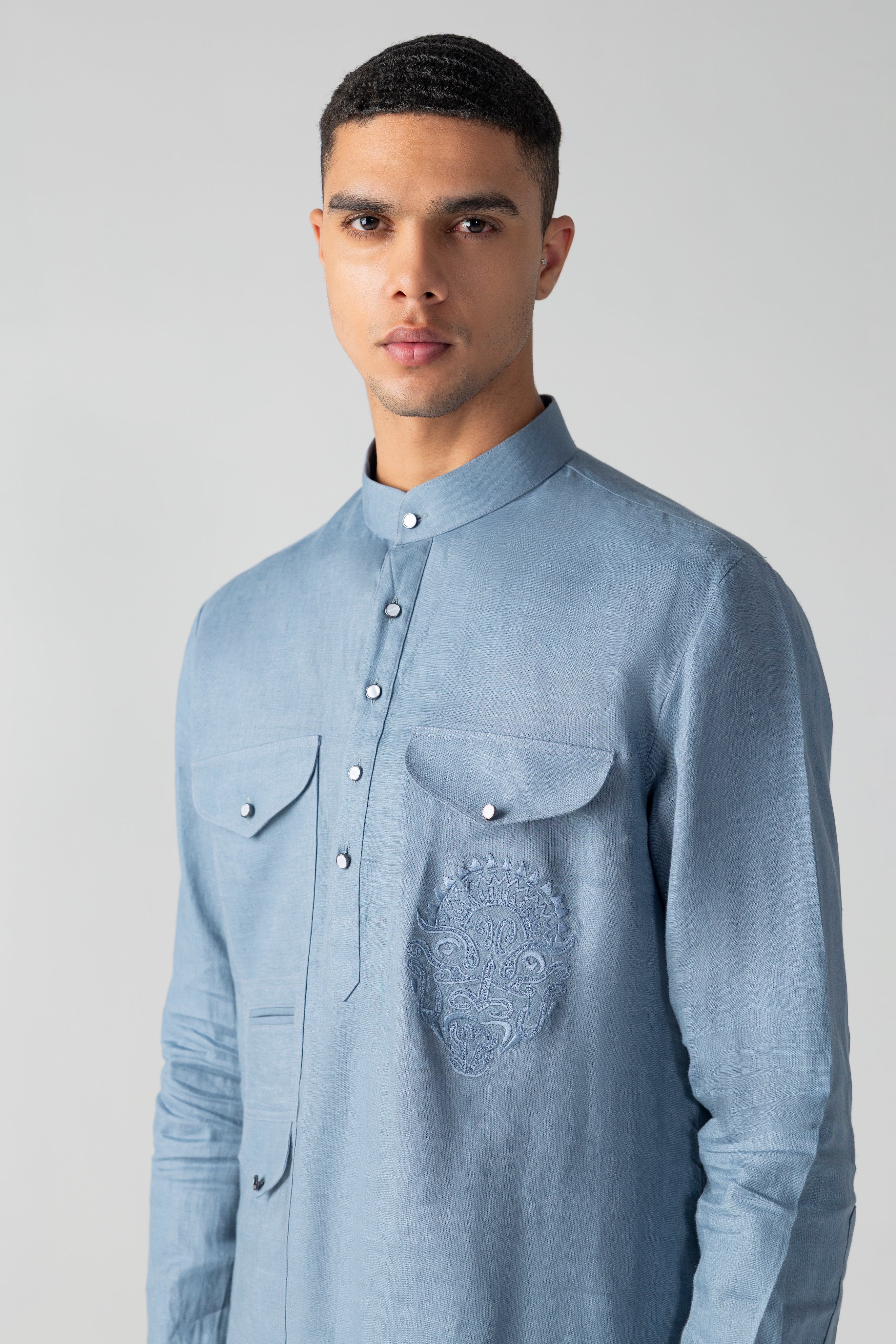 Navy blue linen short kurta with patch pocket & thread embroidery detailing, paired with a matching plazzo
