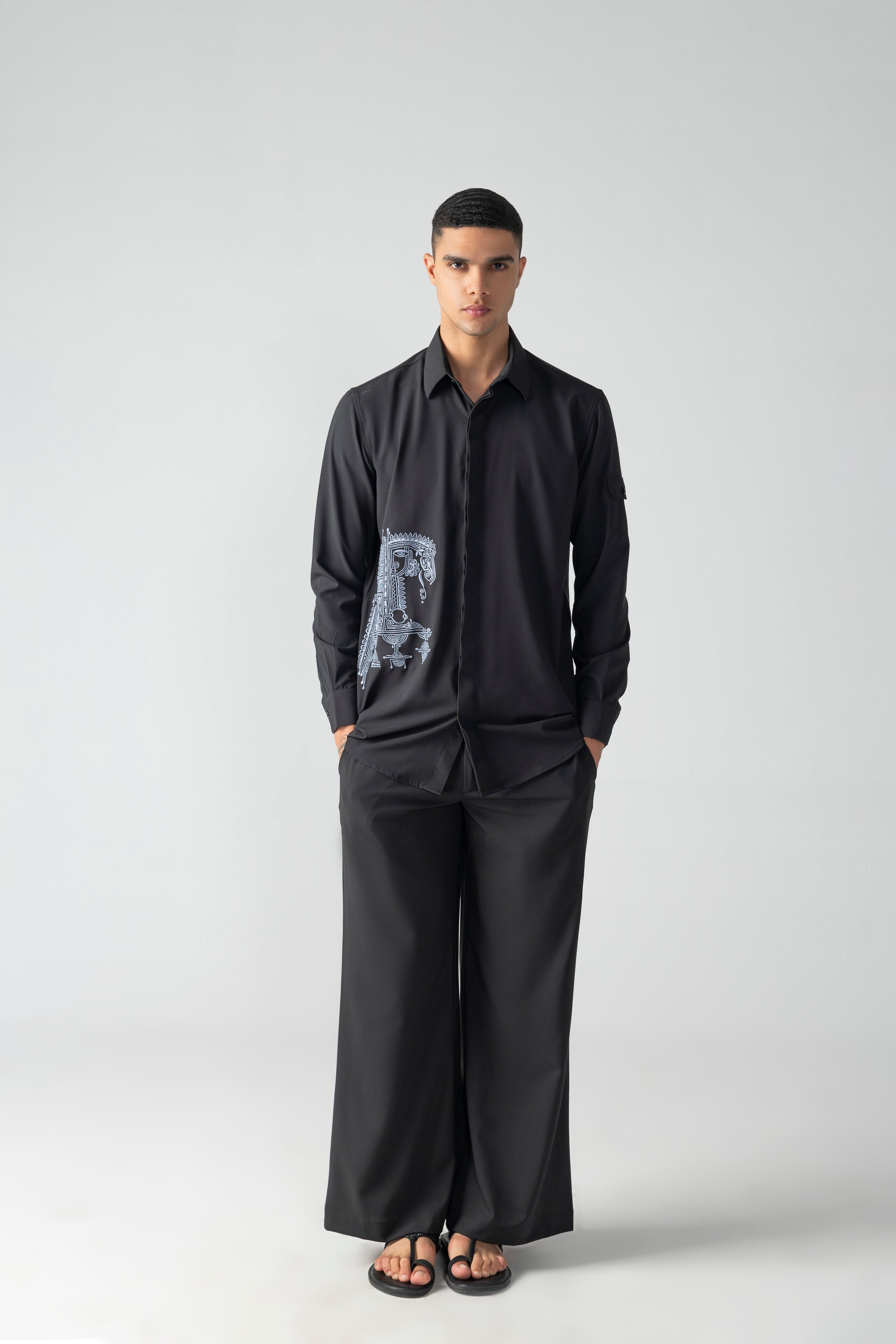 Black crepe shirt with hidden button placket and thread embroidery detailing, paired with a matching plazzo
