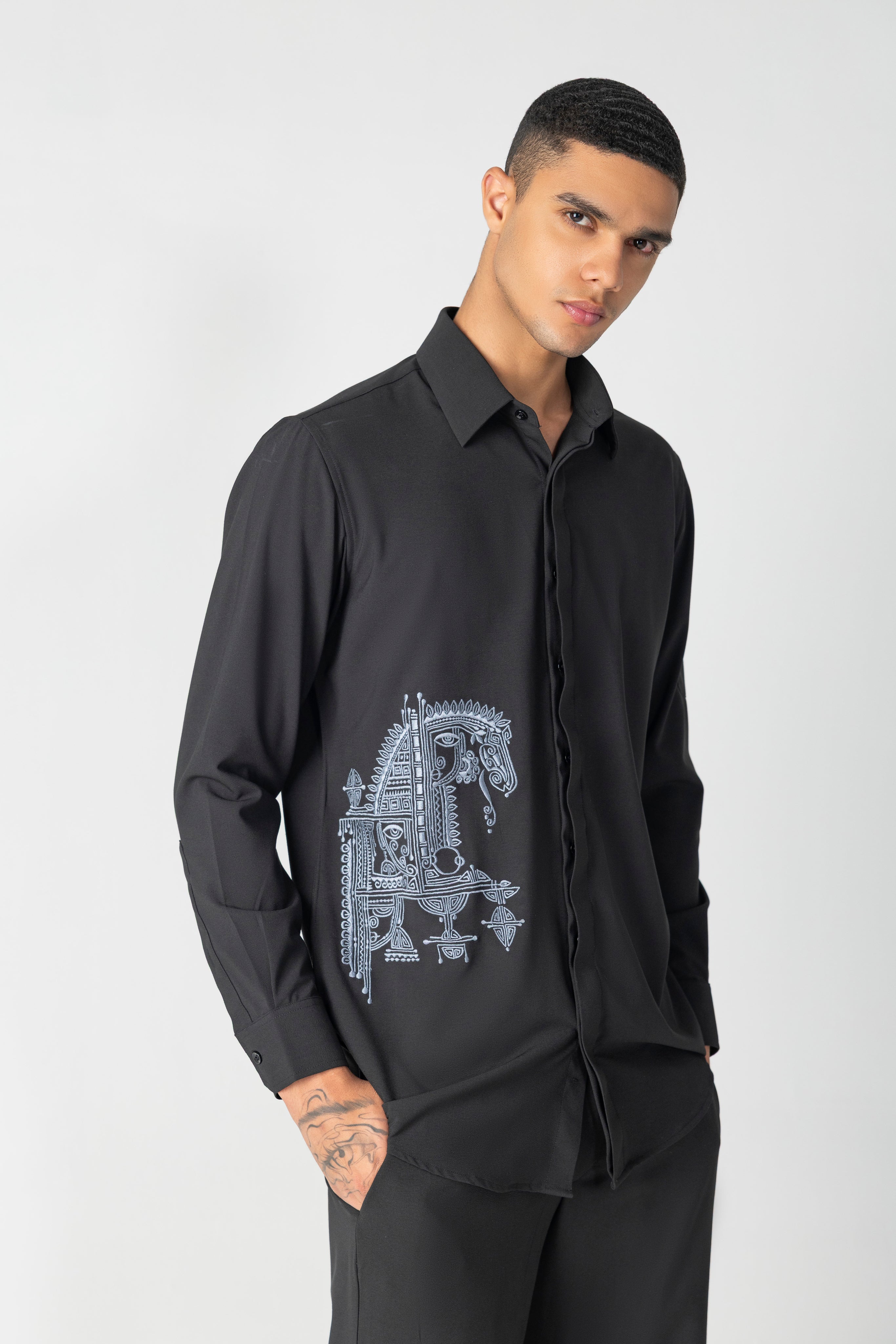 Black crepe shirt with hidden button placket and thread embroidery detailing, paired with a matching plazzo