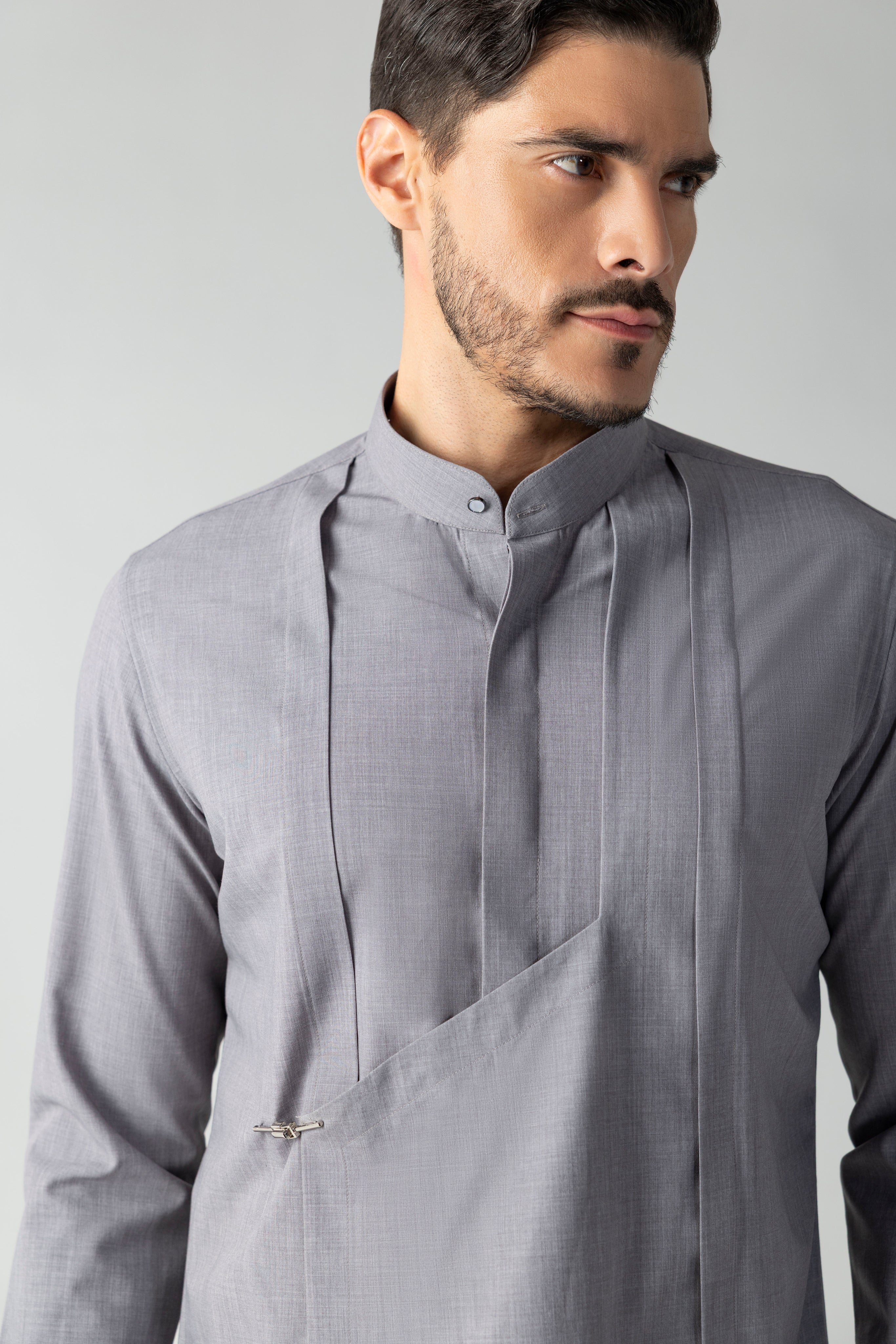 Grey shirt with asymmetrical flap, pleating & hook detailing