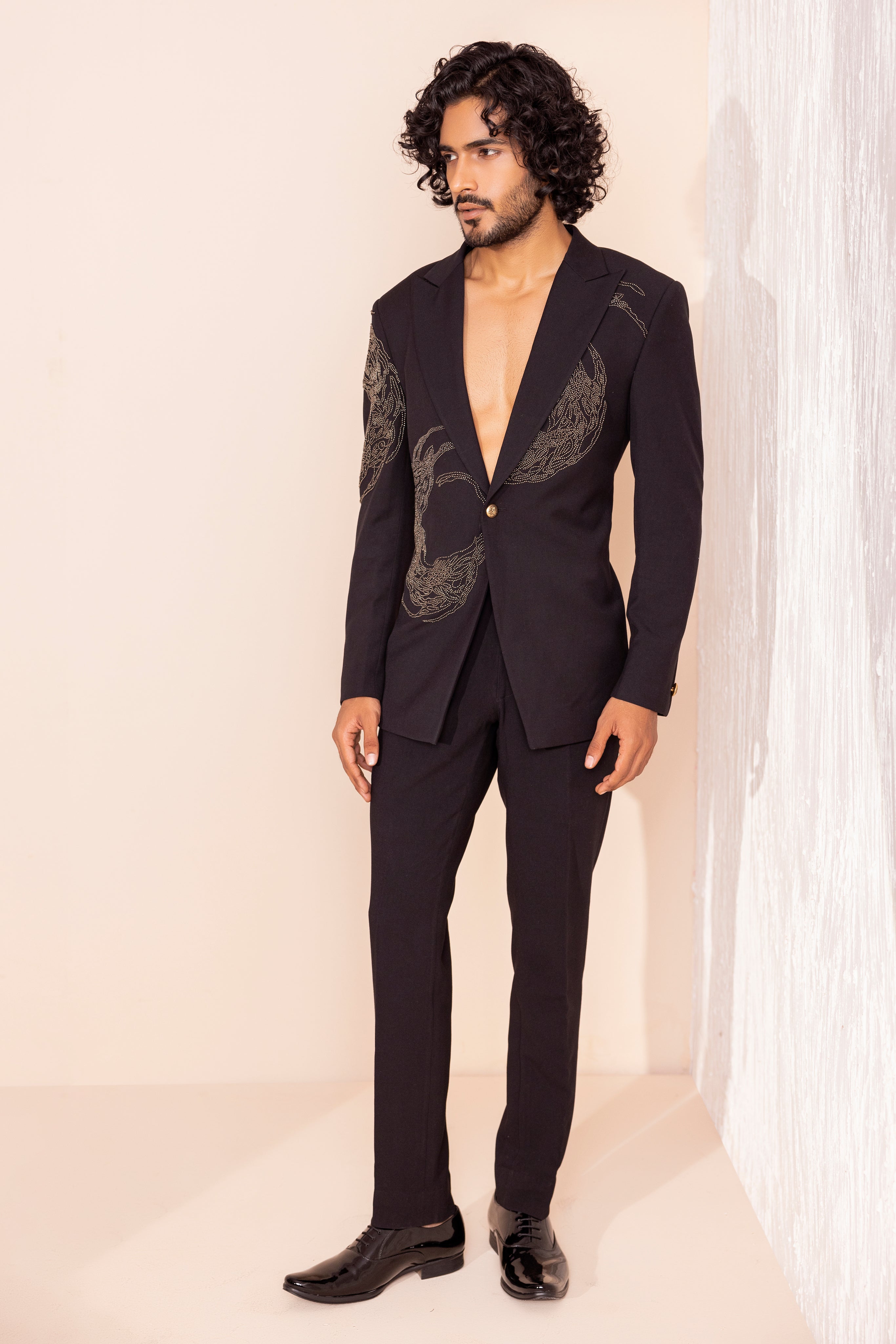 Hand embroidered metal work coat paired with matching pants.