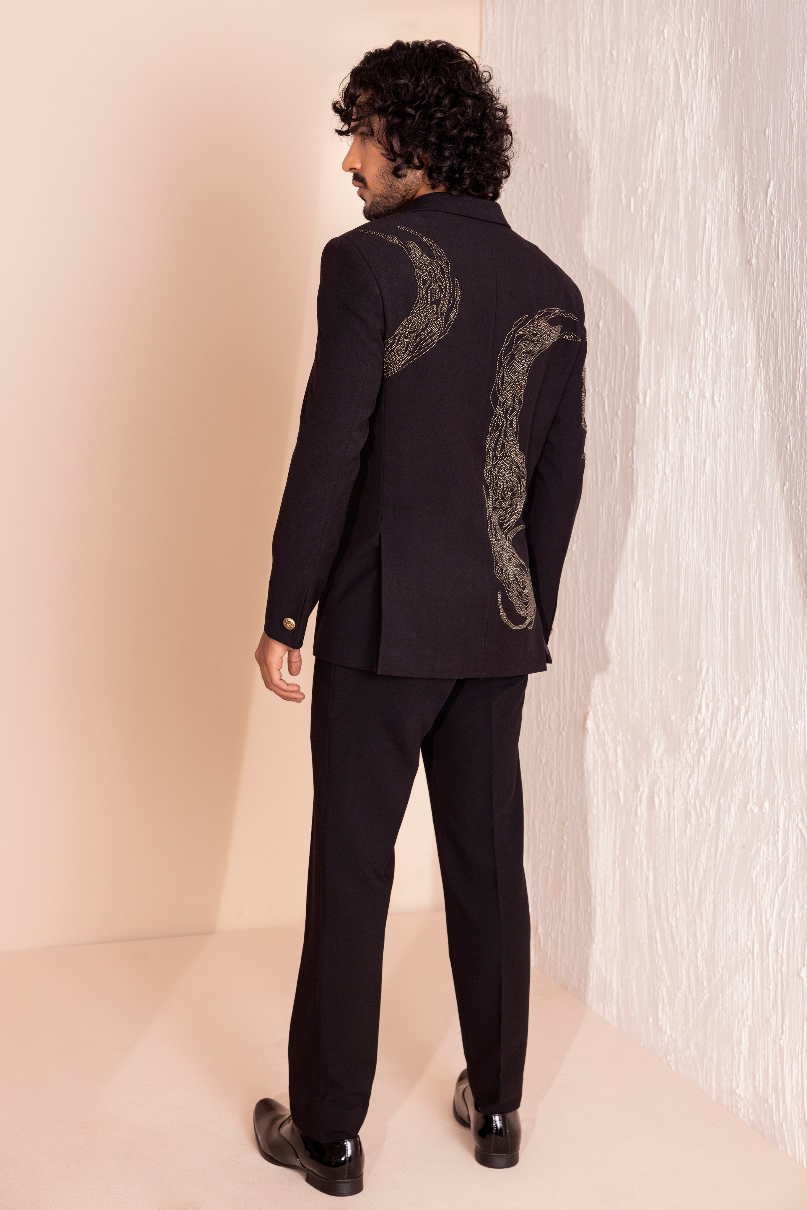 Hand embroidered metal work coat paired with matching pants.