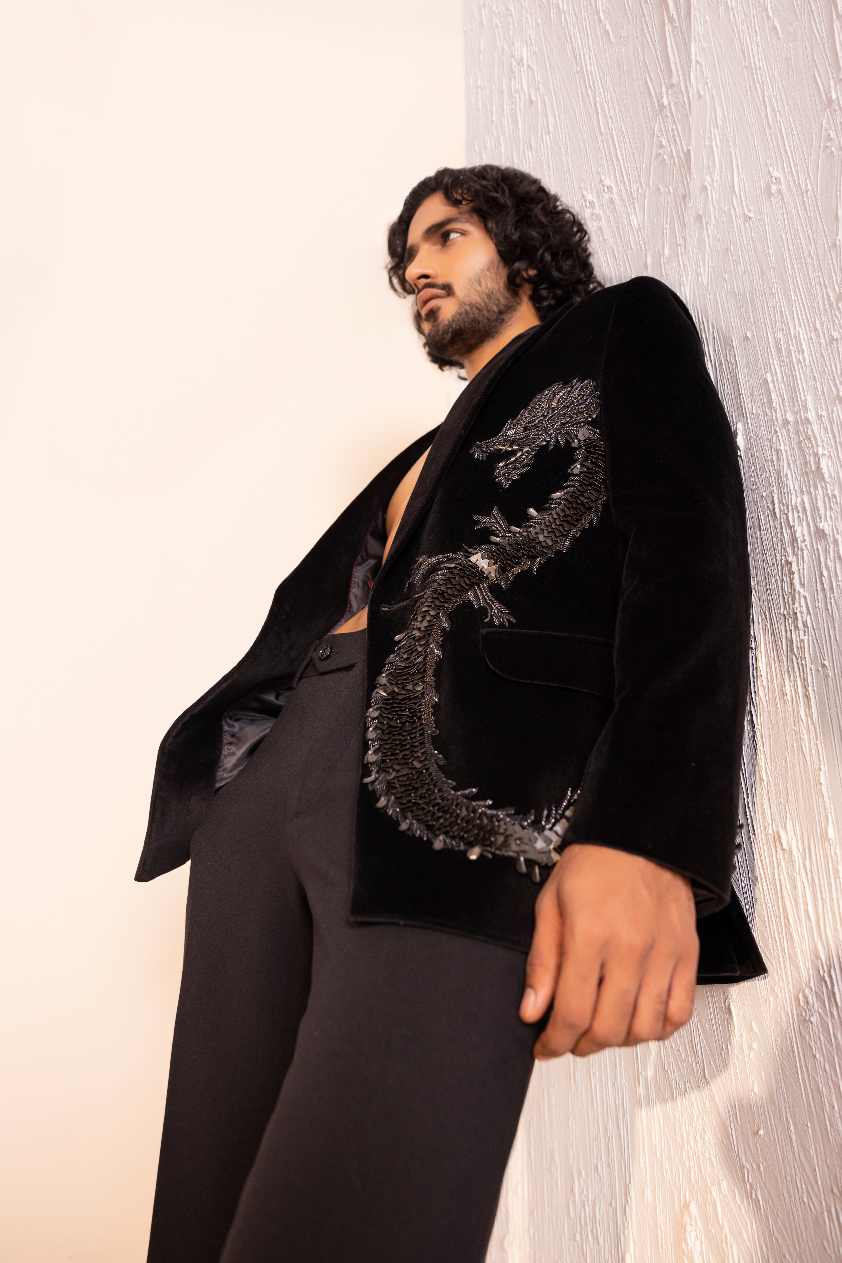 Velvet coat embellished with Dragon motif using metal elements paired with pants.