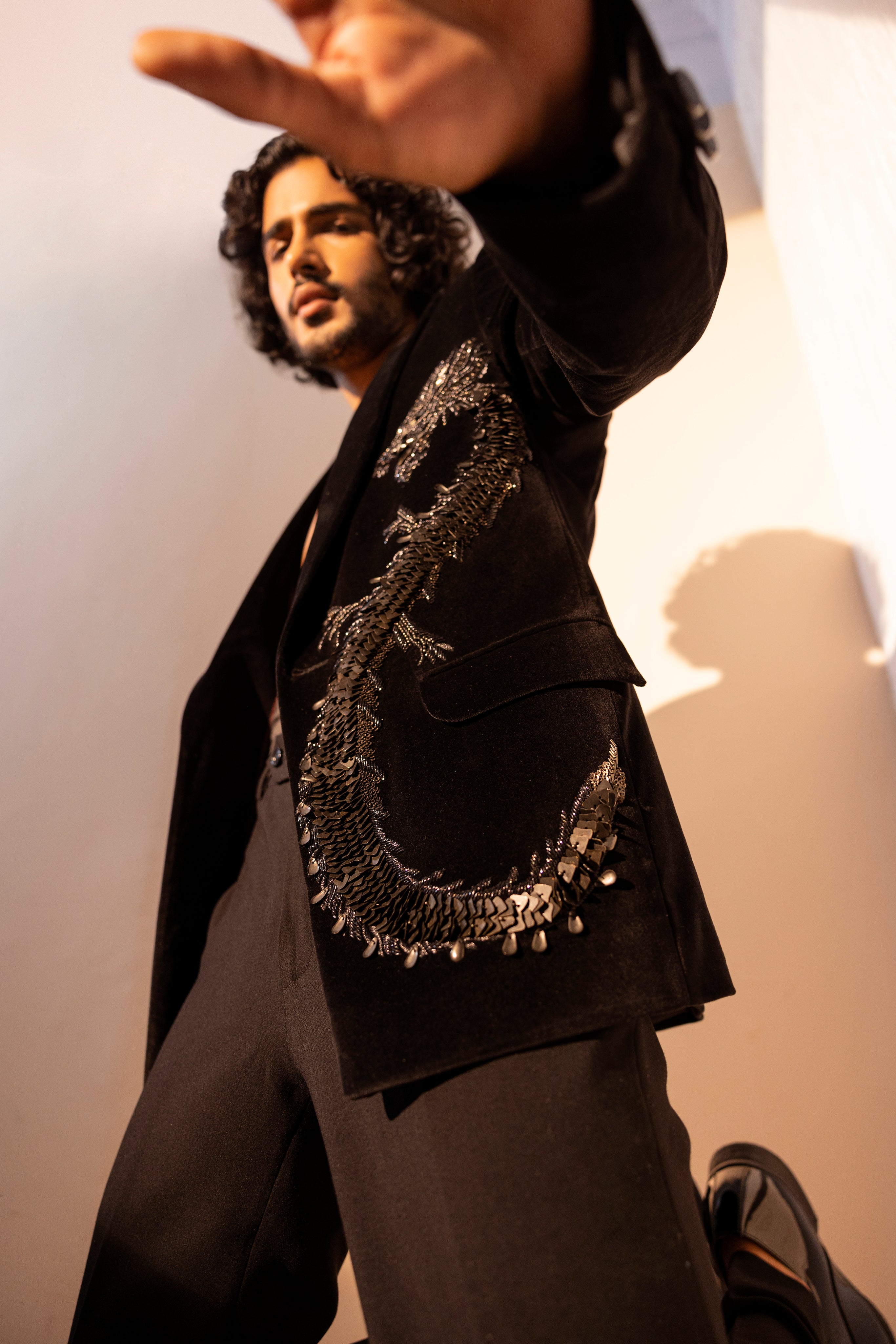 Velvet coat embellished with Dragon motif using metal elements paired with pants.