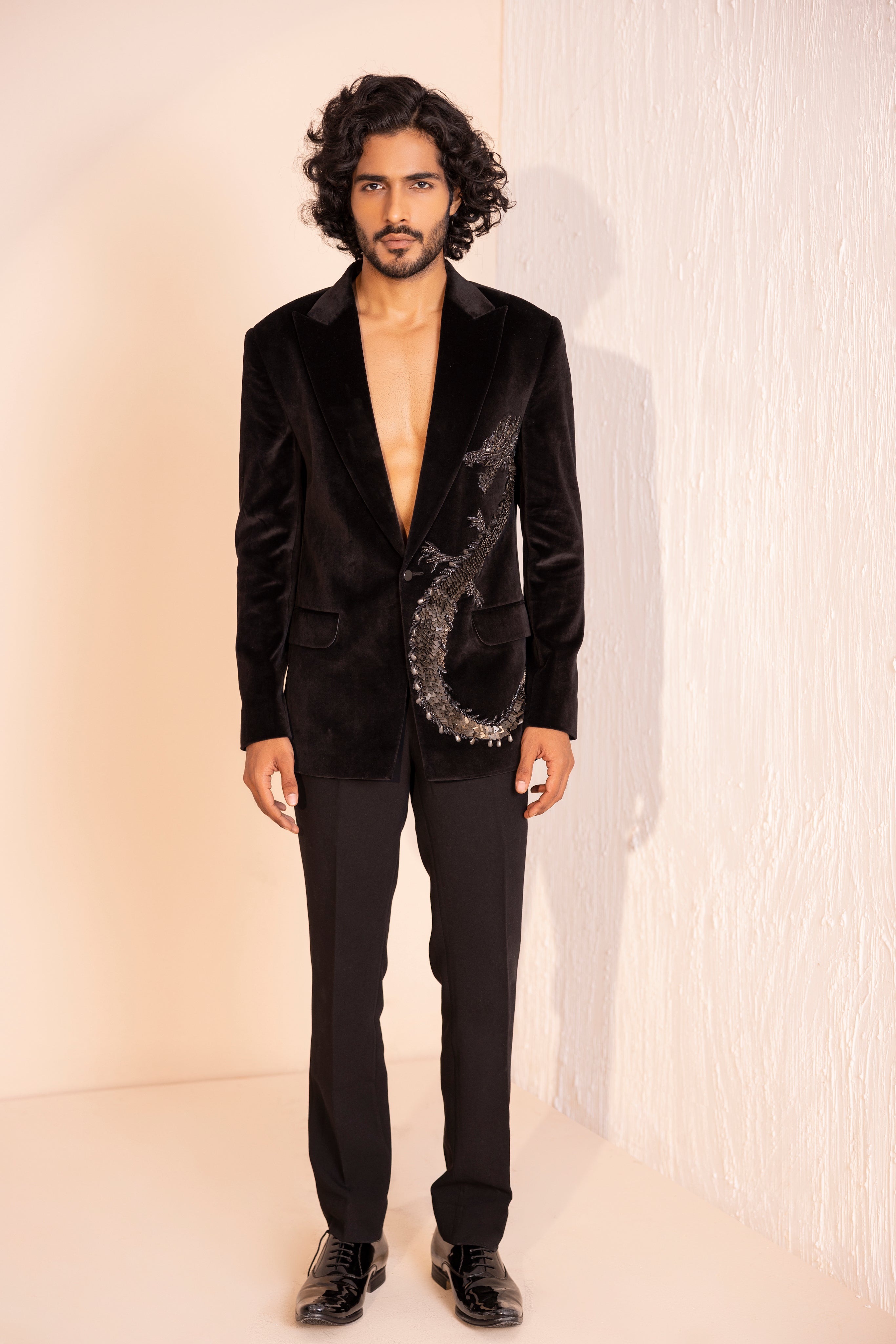 Velvet coat embellished with Dragon motif using metal elements paired with pants.