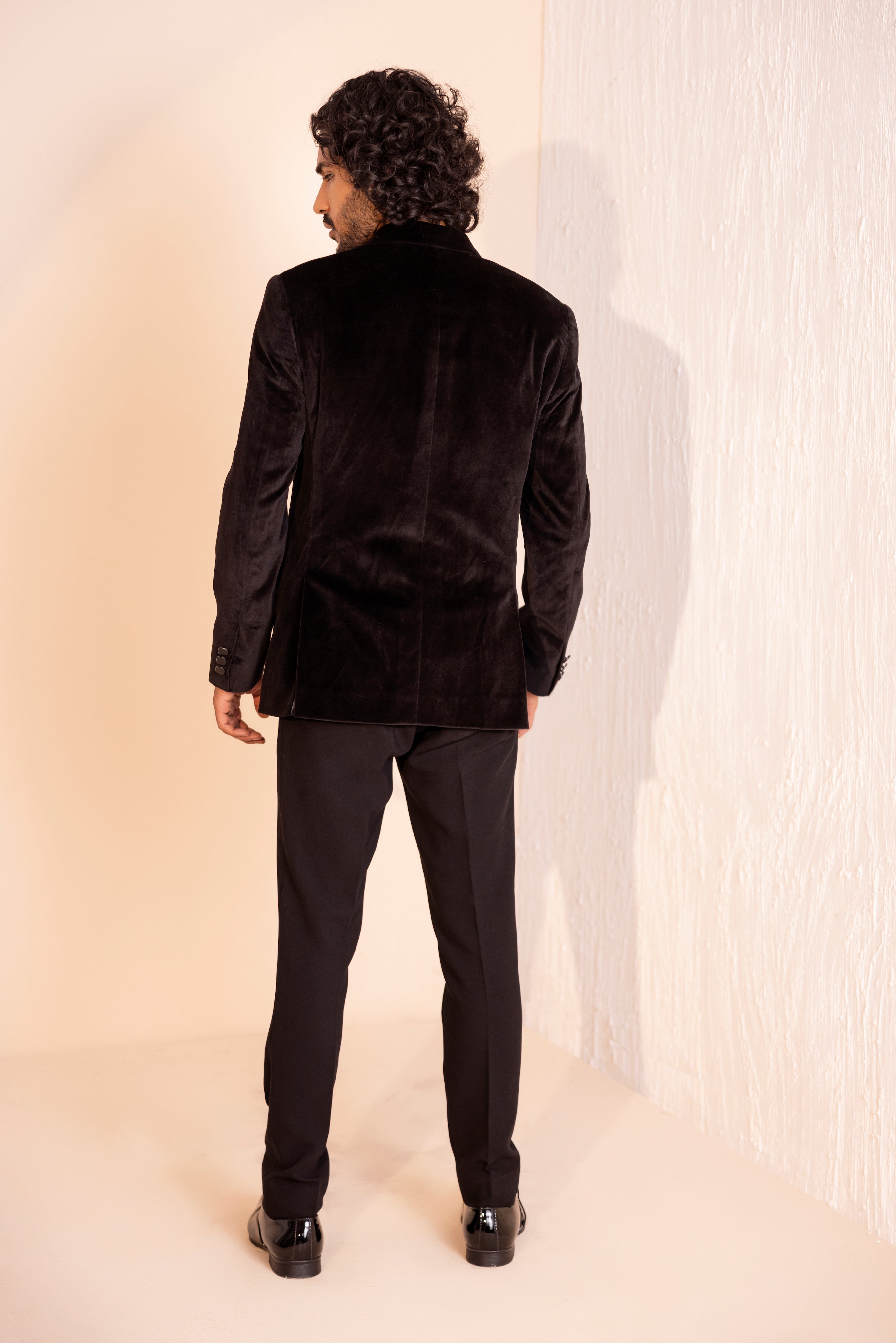 Velvet coat embellished with Dragon motif using metal elements paired with pants.