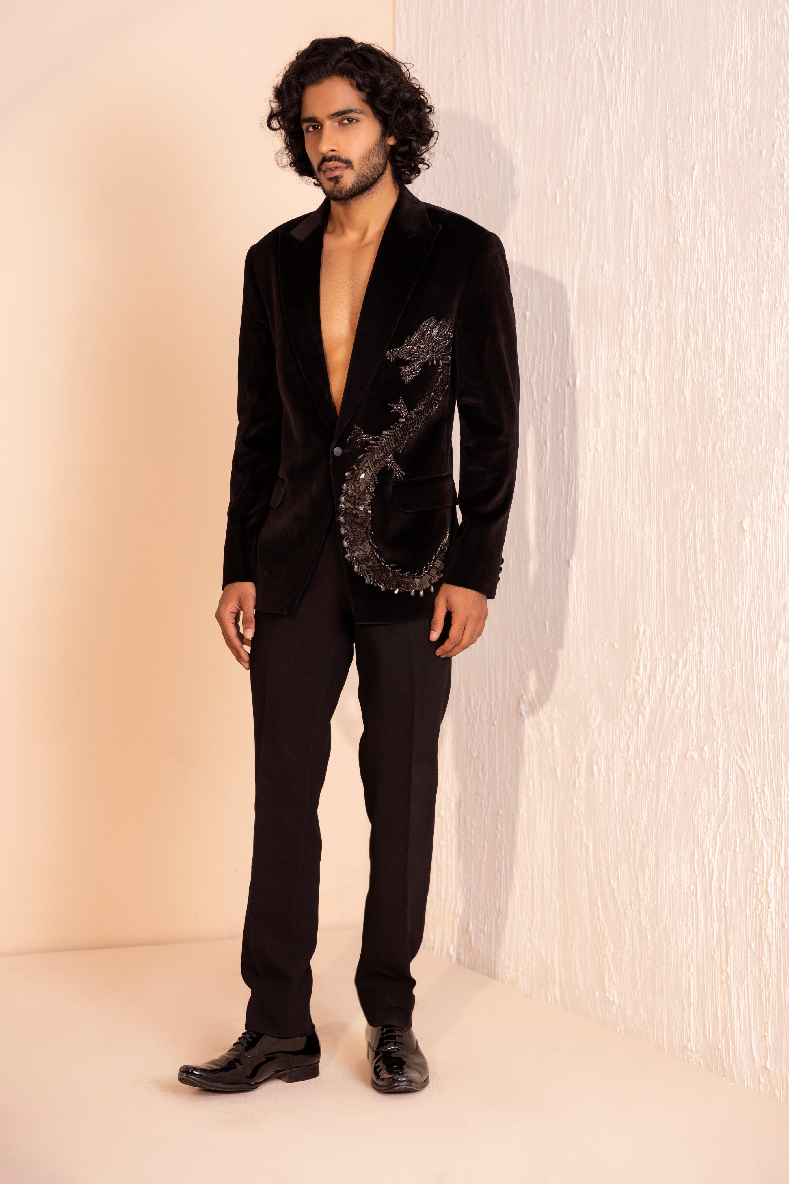 Velvet coat embellished with Dragon motif using metal elements paired with pants.