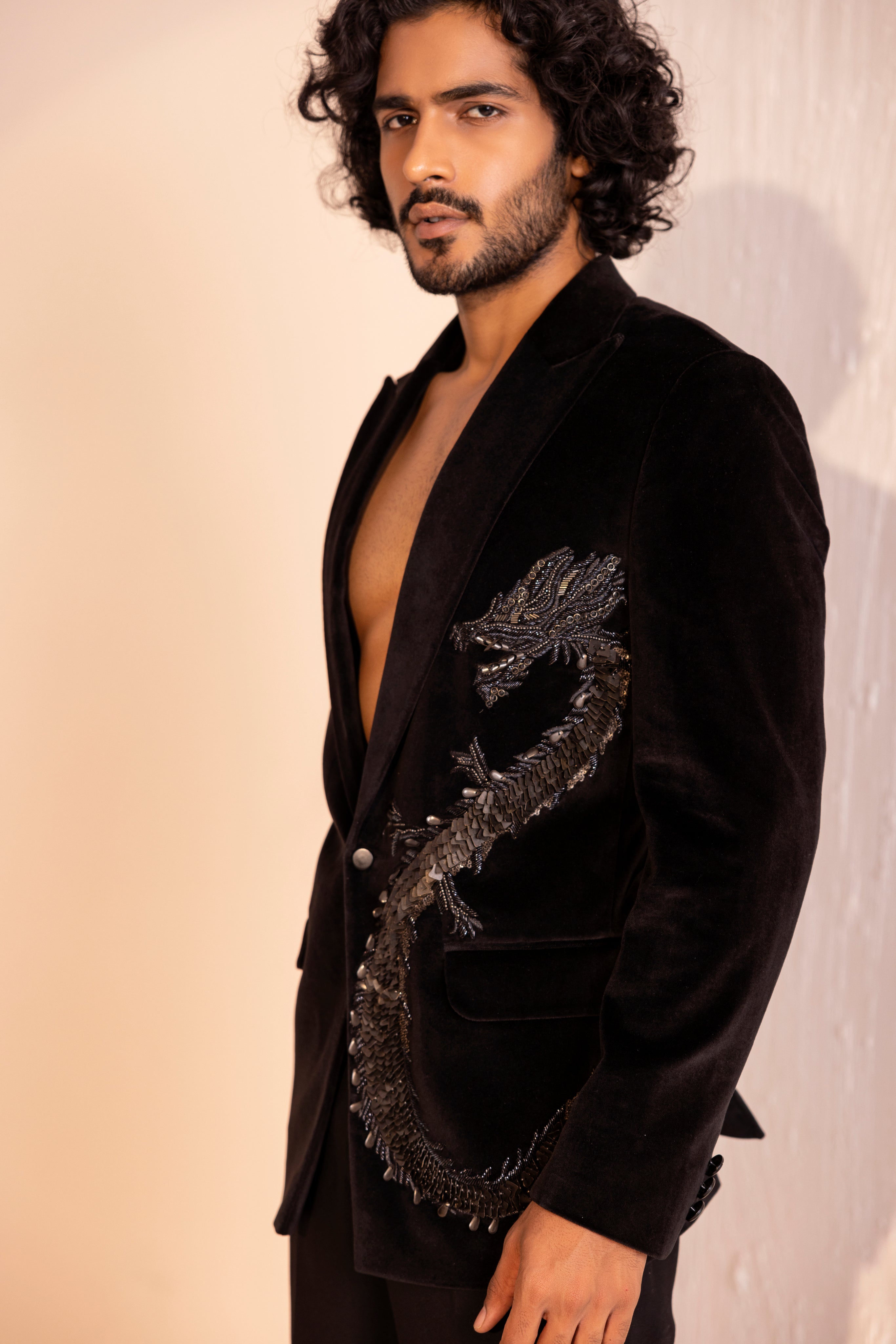 Velvet coat embellished with Dragon motif using metal elements paired with pants.