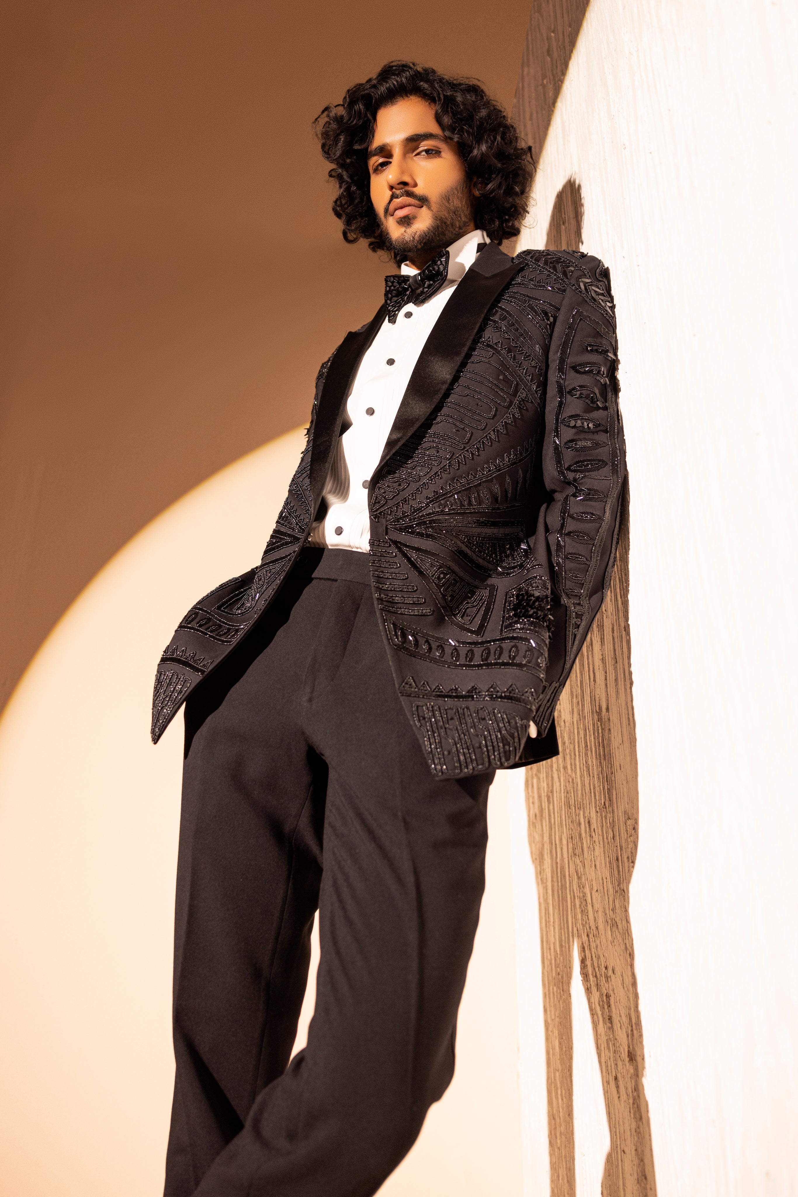 Hand embroidered detailed tuxedo jacket paired with matching pants.