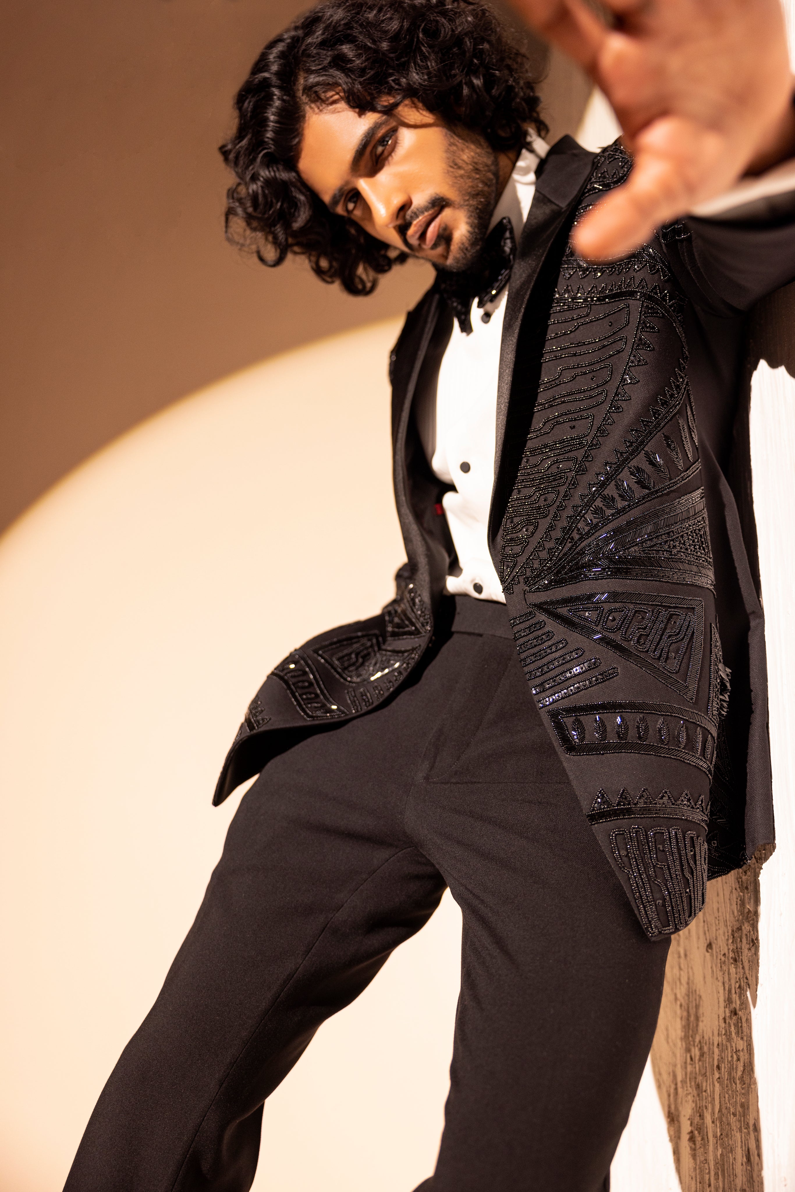 Hand embroidered detailed tuxedo jacket paired with matching pants.