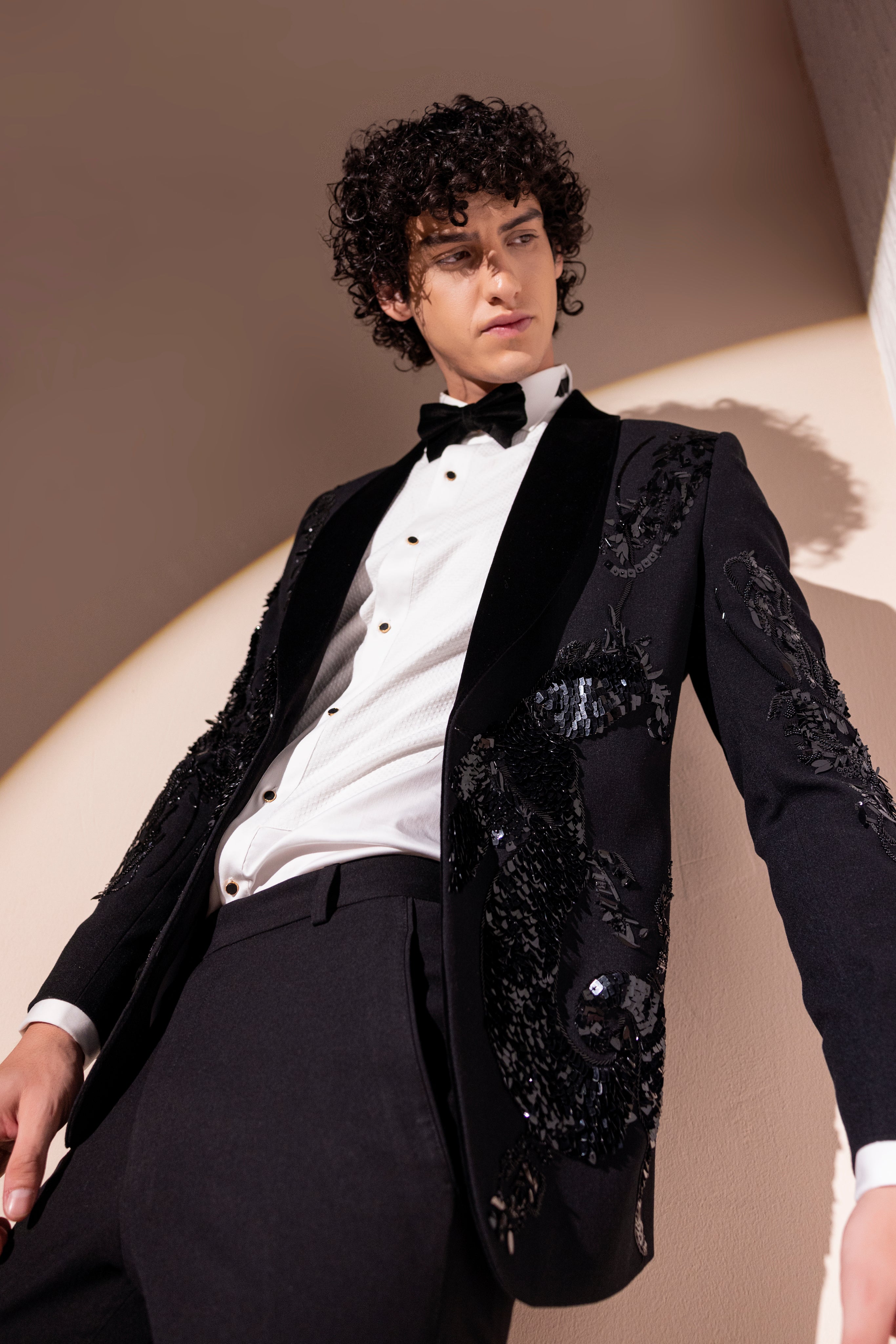 Hand embroidered motif tuxedo jacket paired with matching pants.