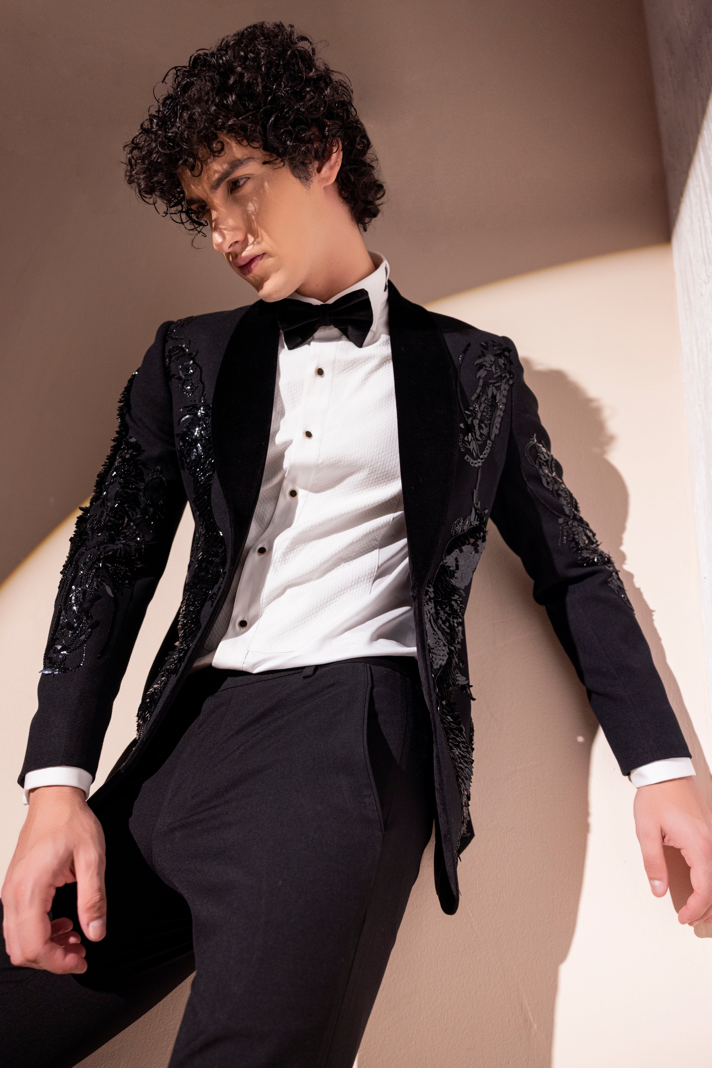 Hand embroidered motif tuxedo jacket paired with matching pants.