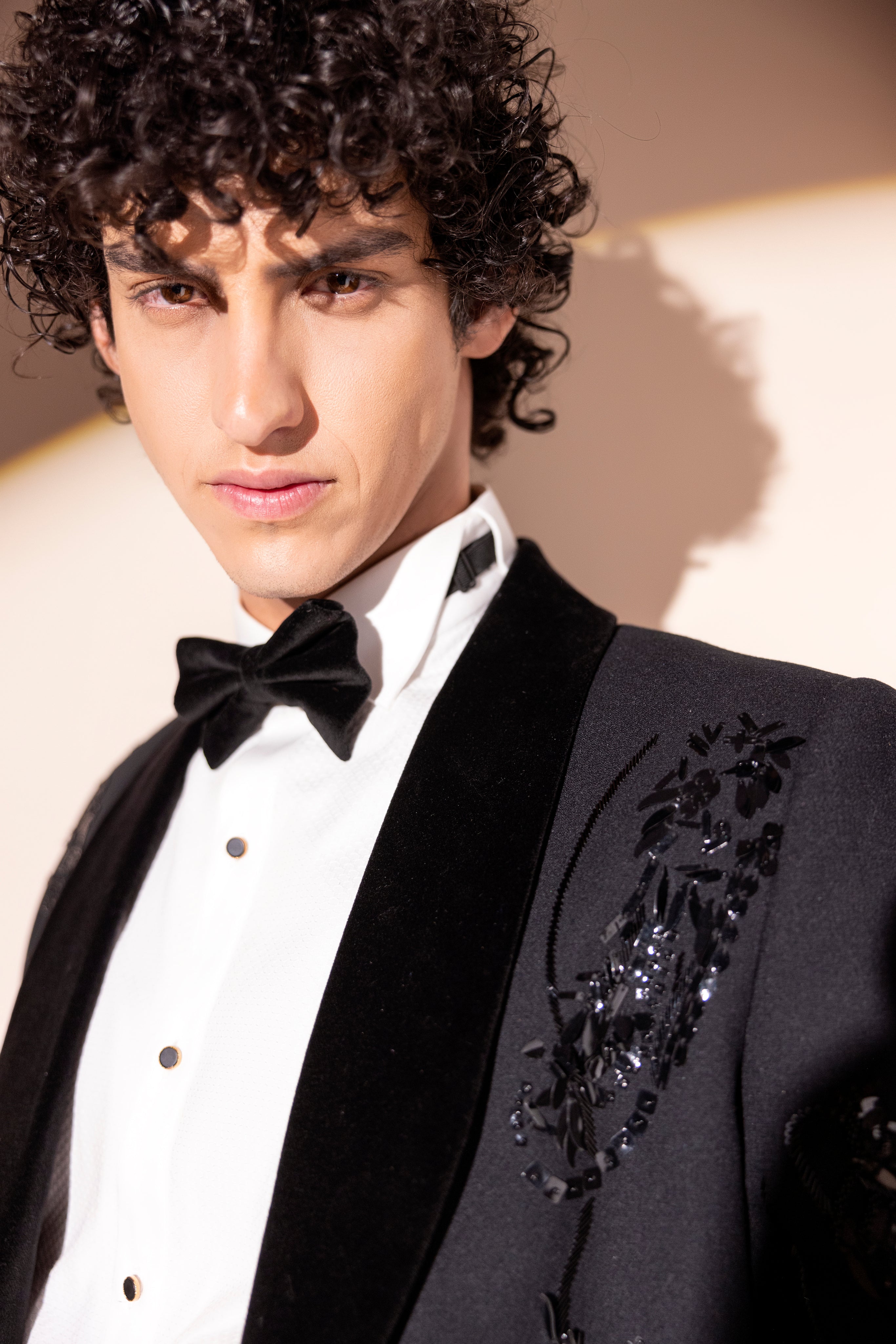 Hand embroidered motif tuxedo jacket paired with matching pants.