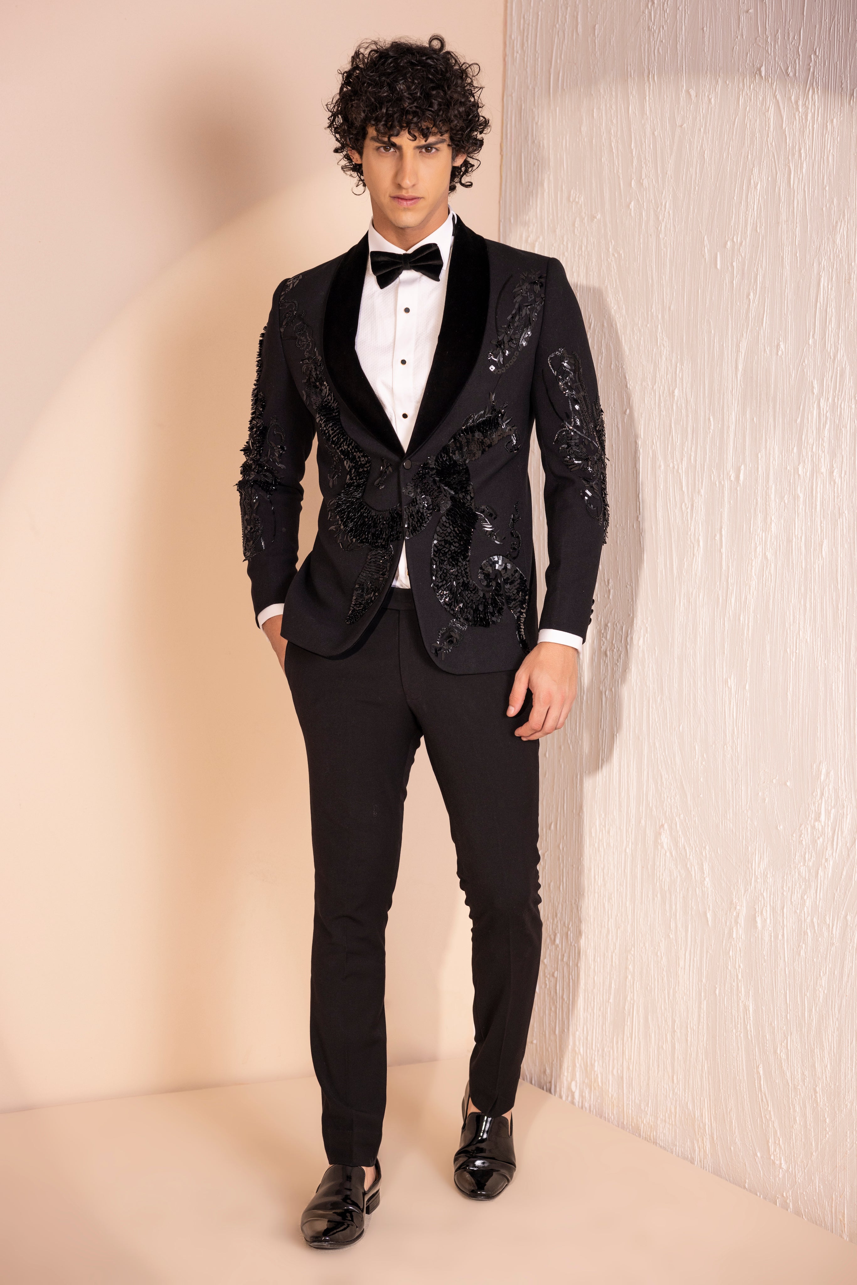 Hand embroidered motif tuxedo jacket paired with matching pants.