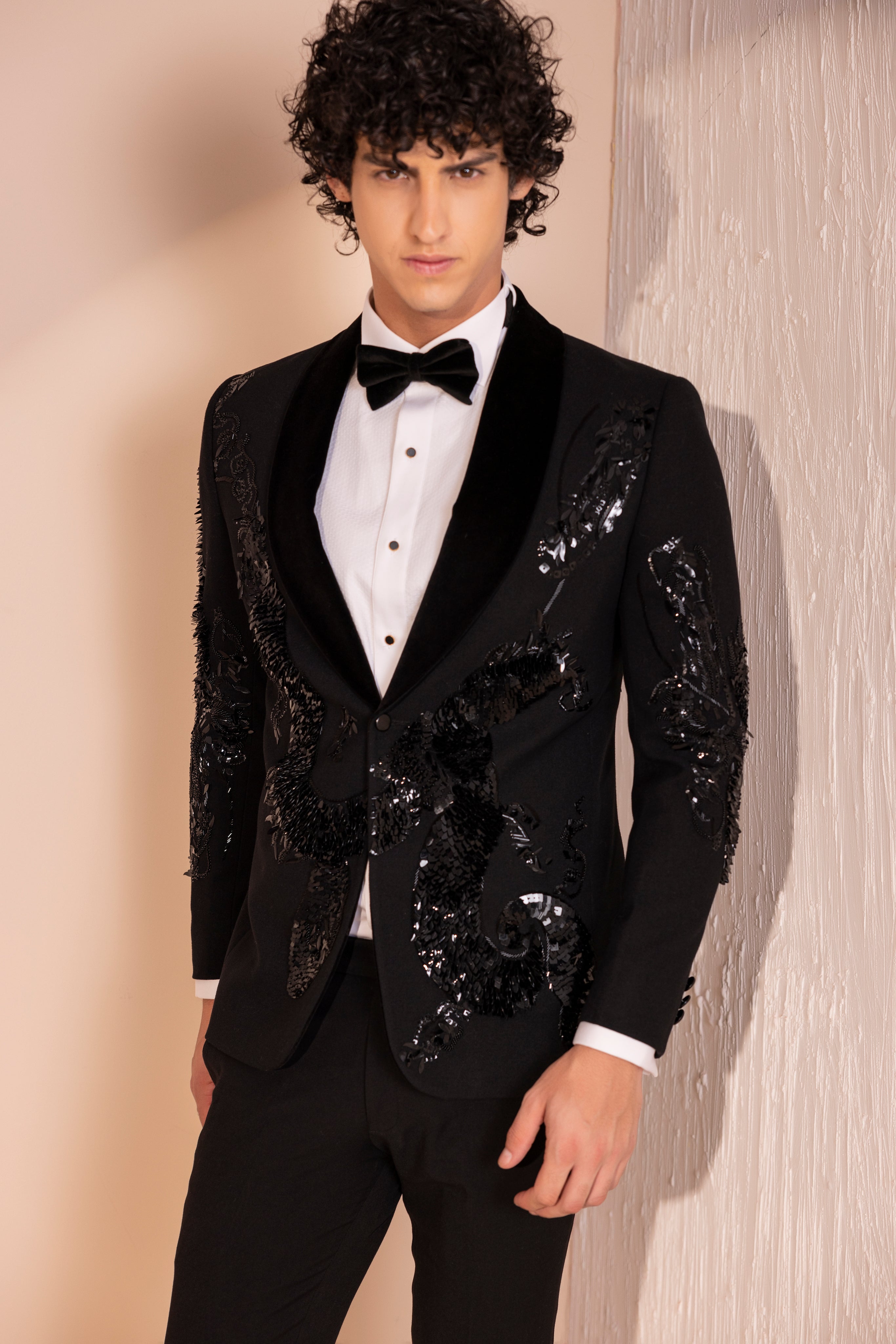 Hand embroidered motif tuxedo jacket paired with matching pants.