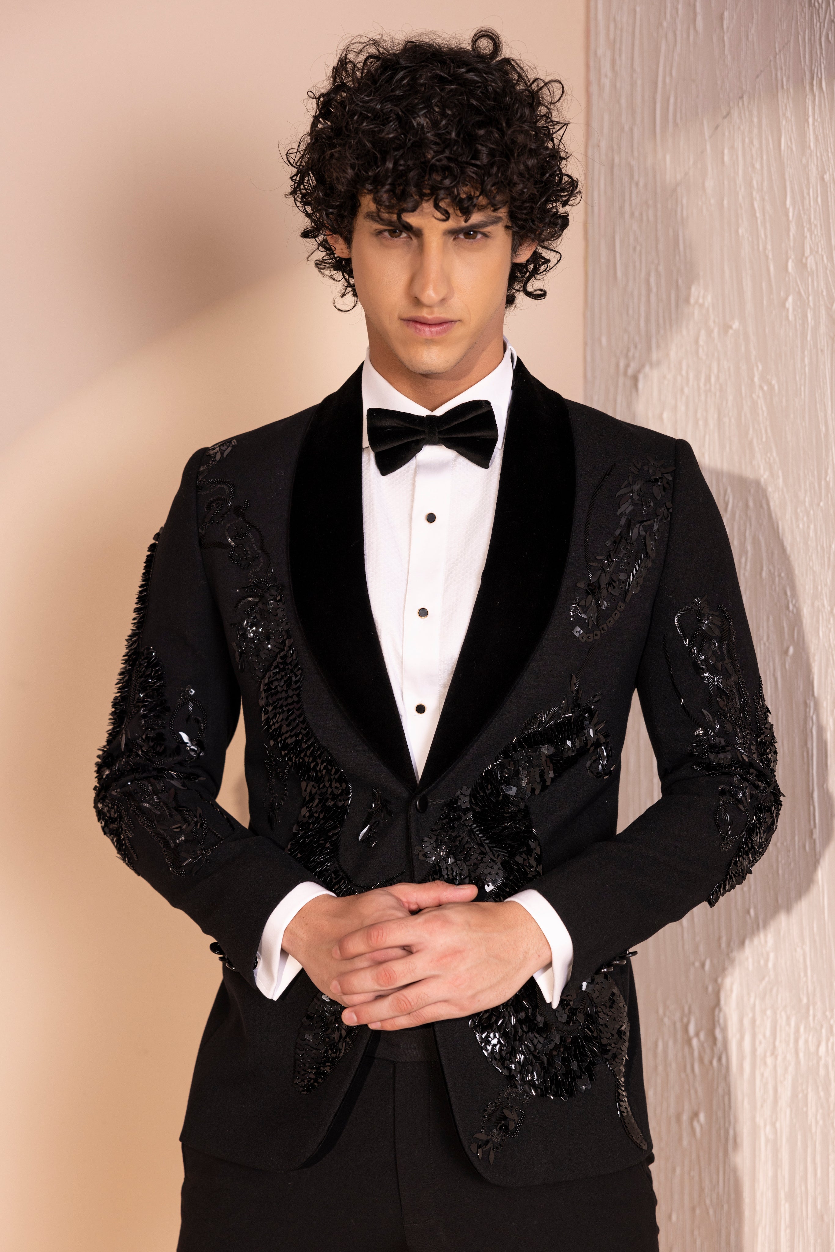 Hand embroidered motif tuxedo jacket paired with matching pants.