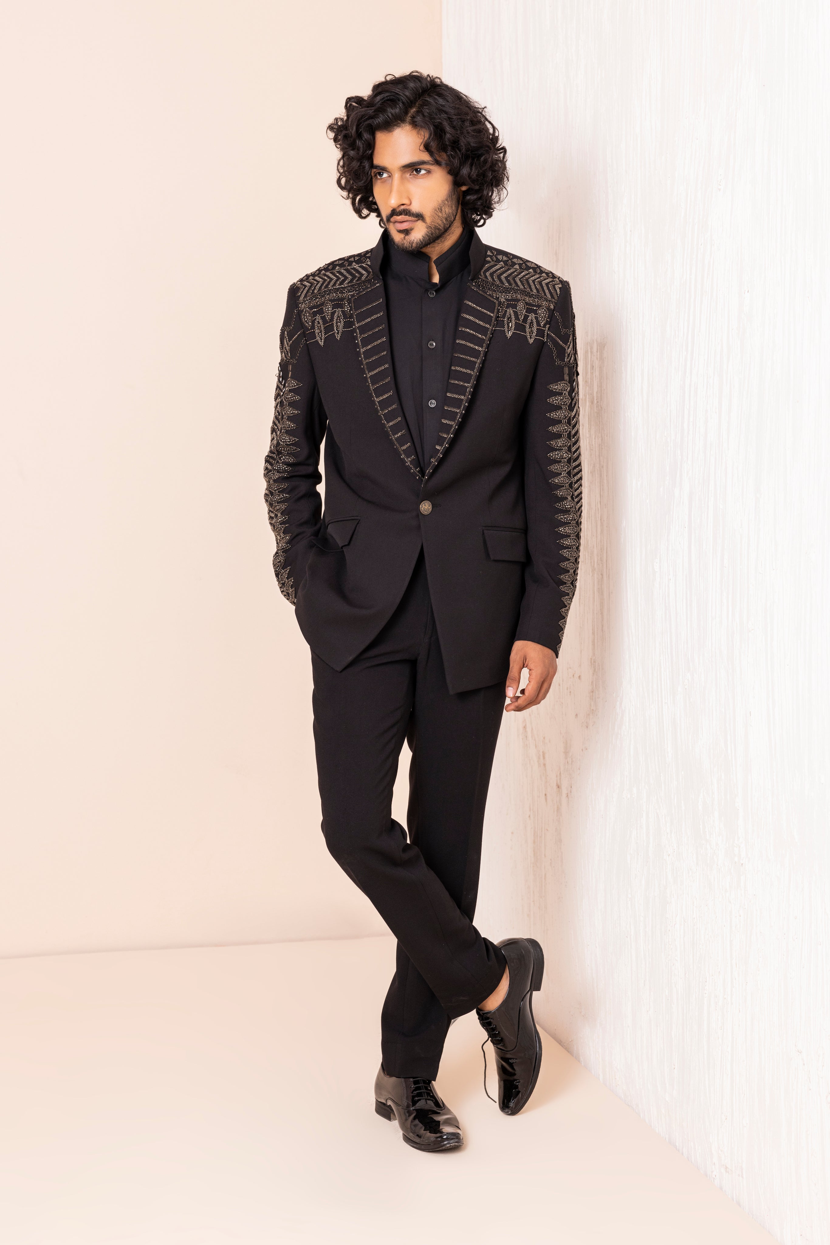 Hand embroidered metal work coat paired with matching pants.