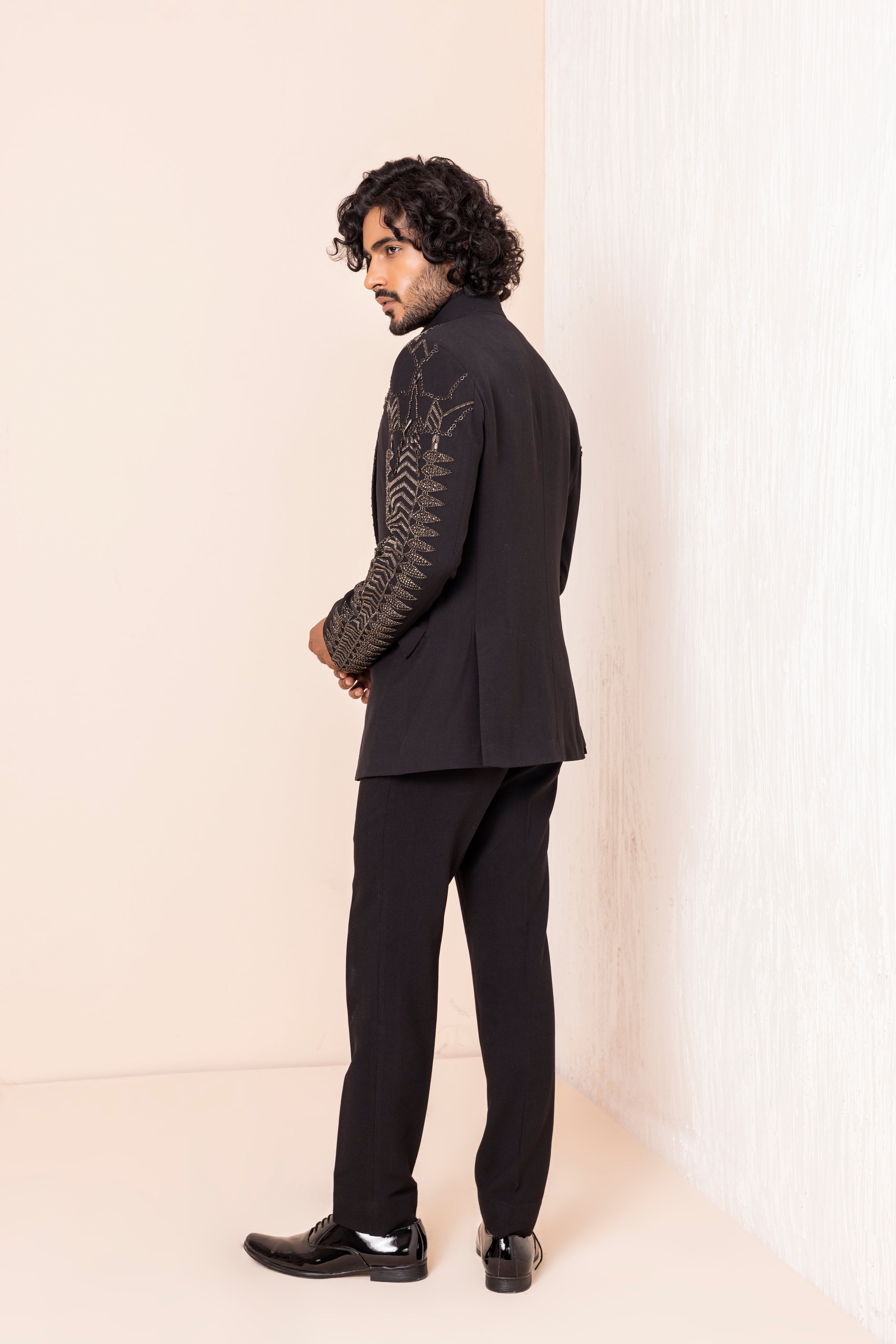 Hand embroidered metal work coat paired with matching pants.