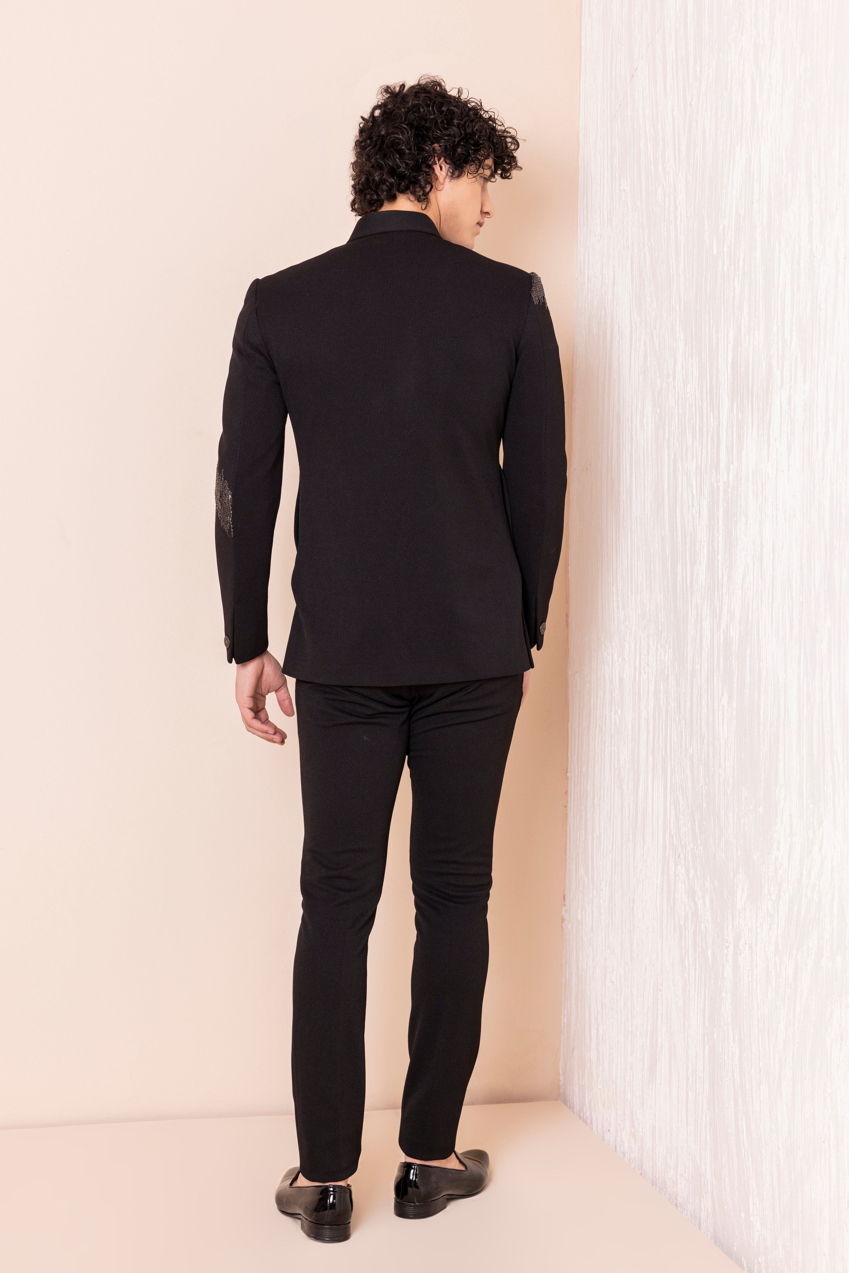 Hand embroidered metal work jodhpuri paired with pants.