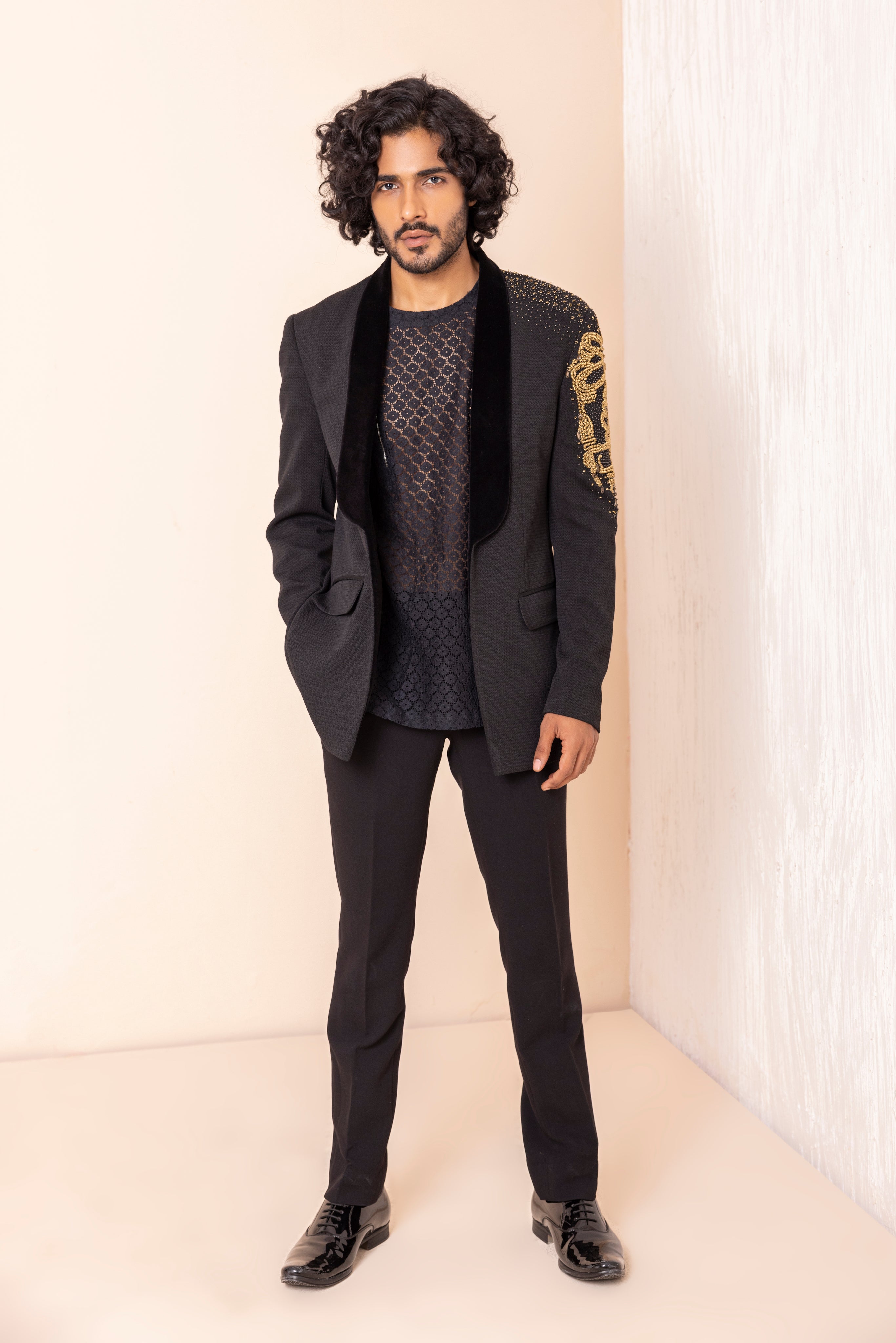 Hand embroidered metal work coat paired with short crochet kurta and pants.