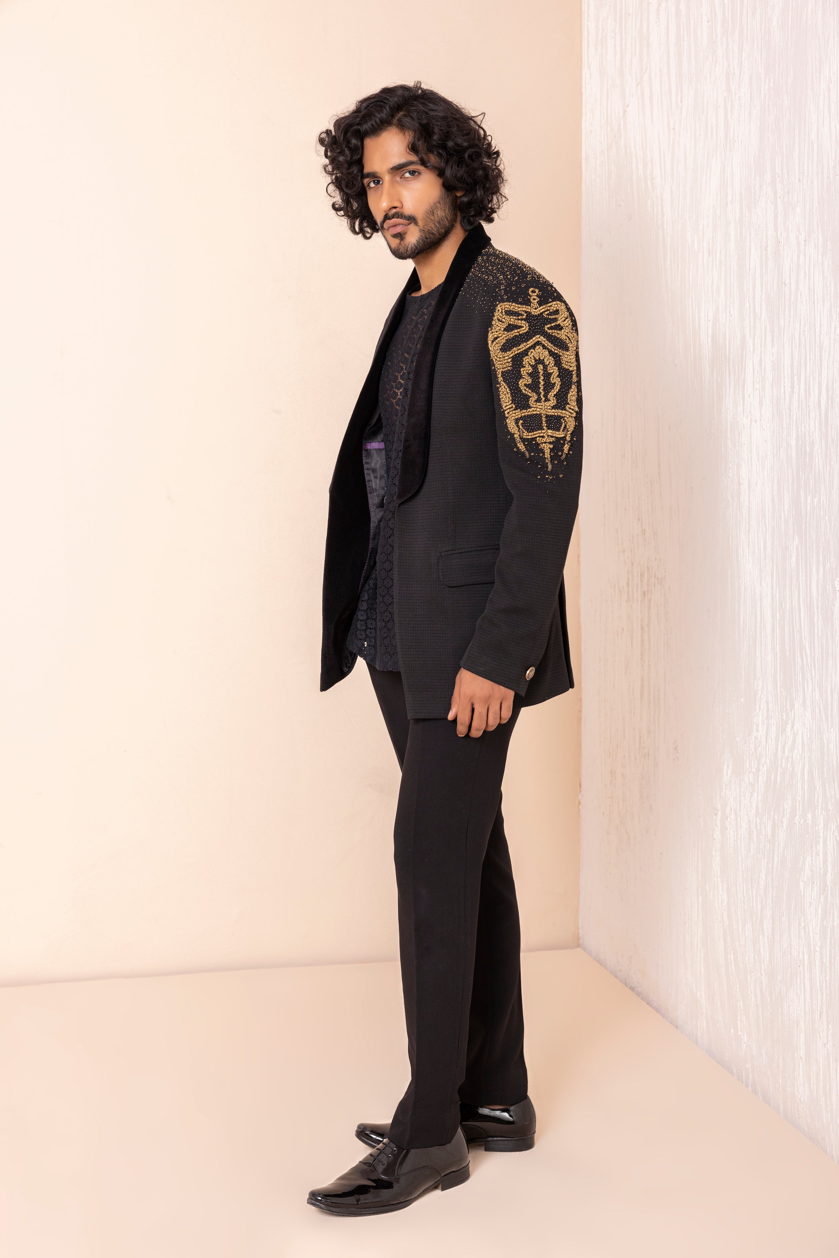 Hand embroidered metal work coat paired with short crochet kurta and pants.