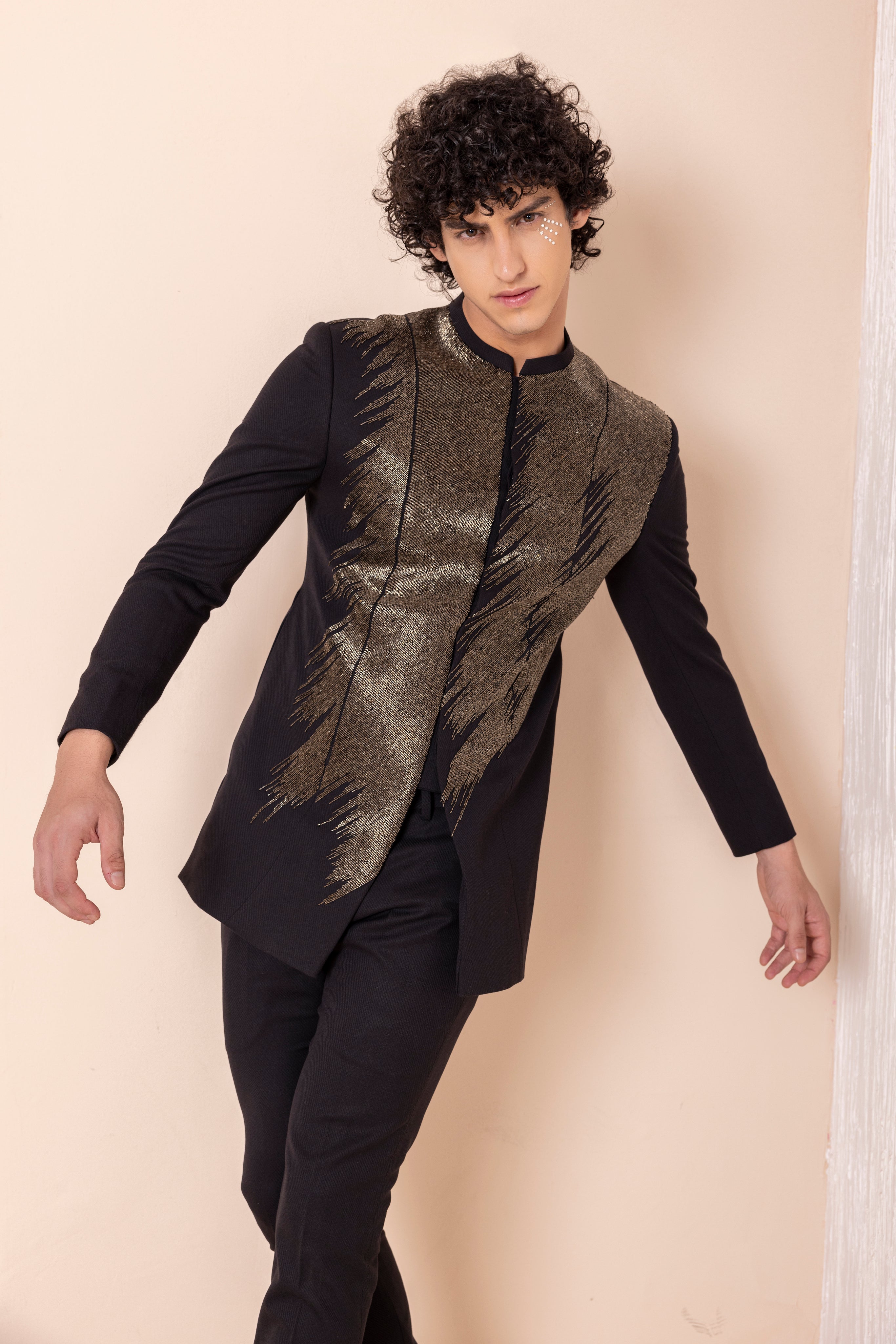 Hand embroidered metal work coat paired with matching pants.