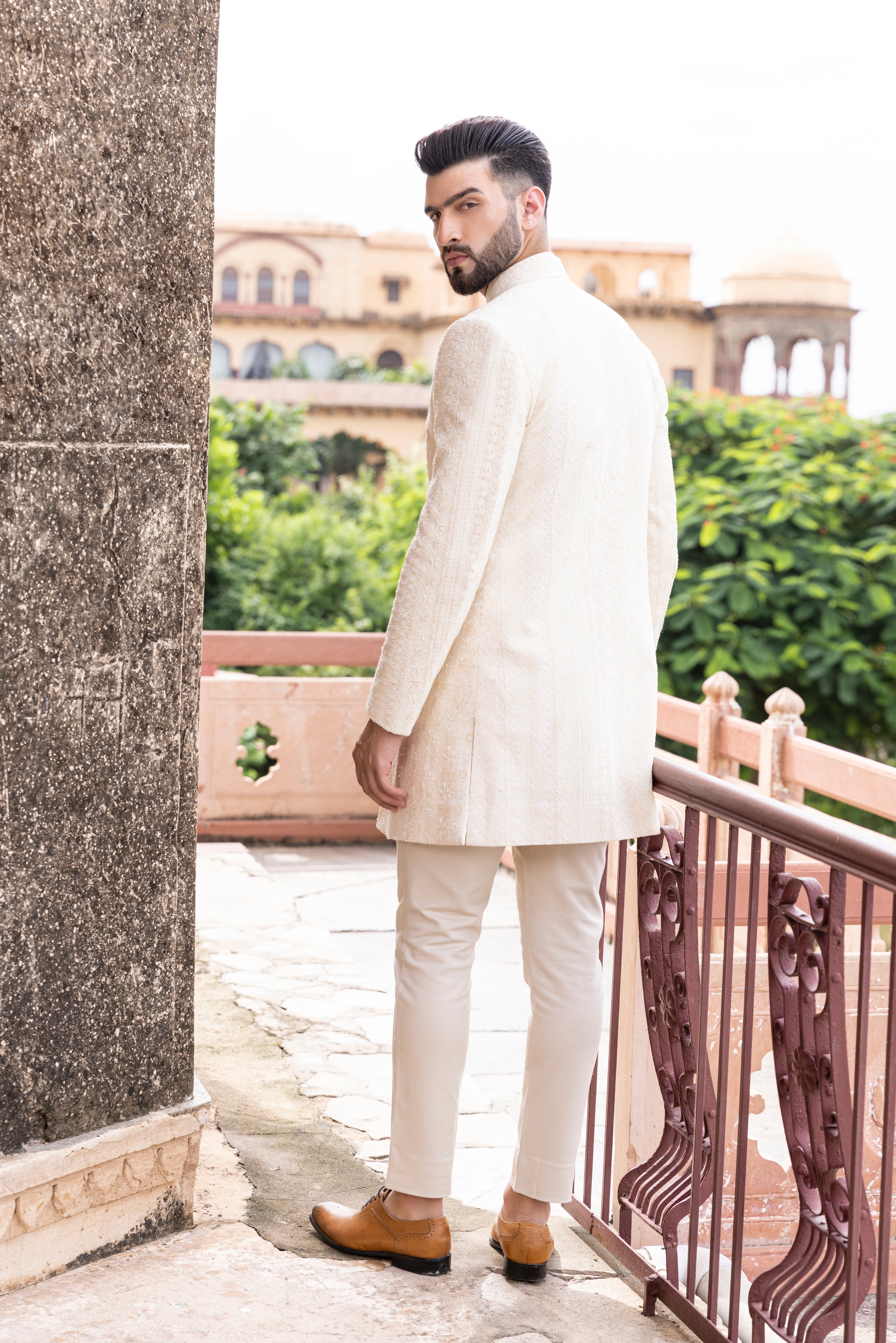 Cream front-open indowestern Crochet jacket highlighted with cut daana hand embroidery paired with a short crochet kurta and pants.