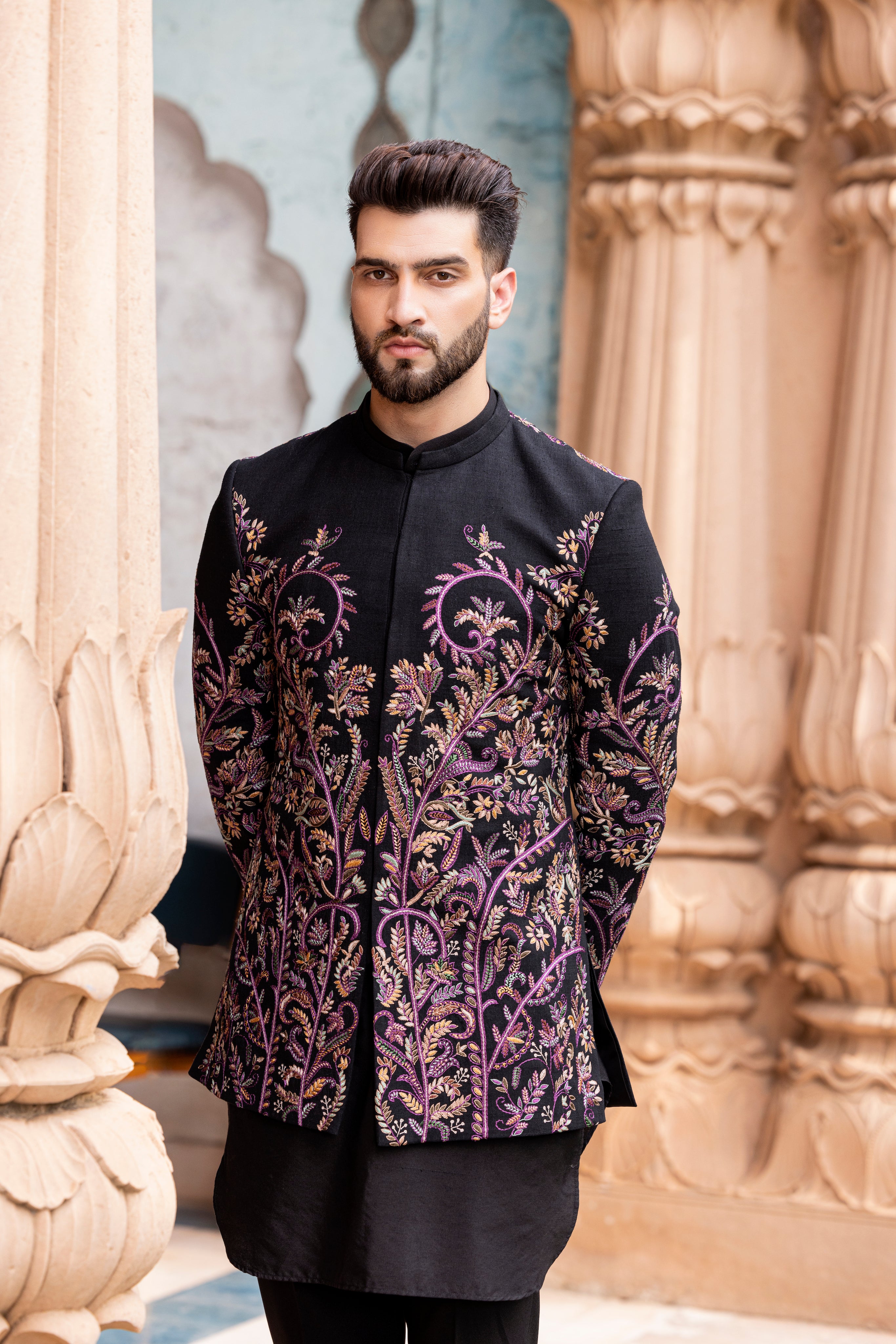 Black silk indowestern jacket embellished with Kashmiri hand embroidery paired with kurta and pants.