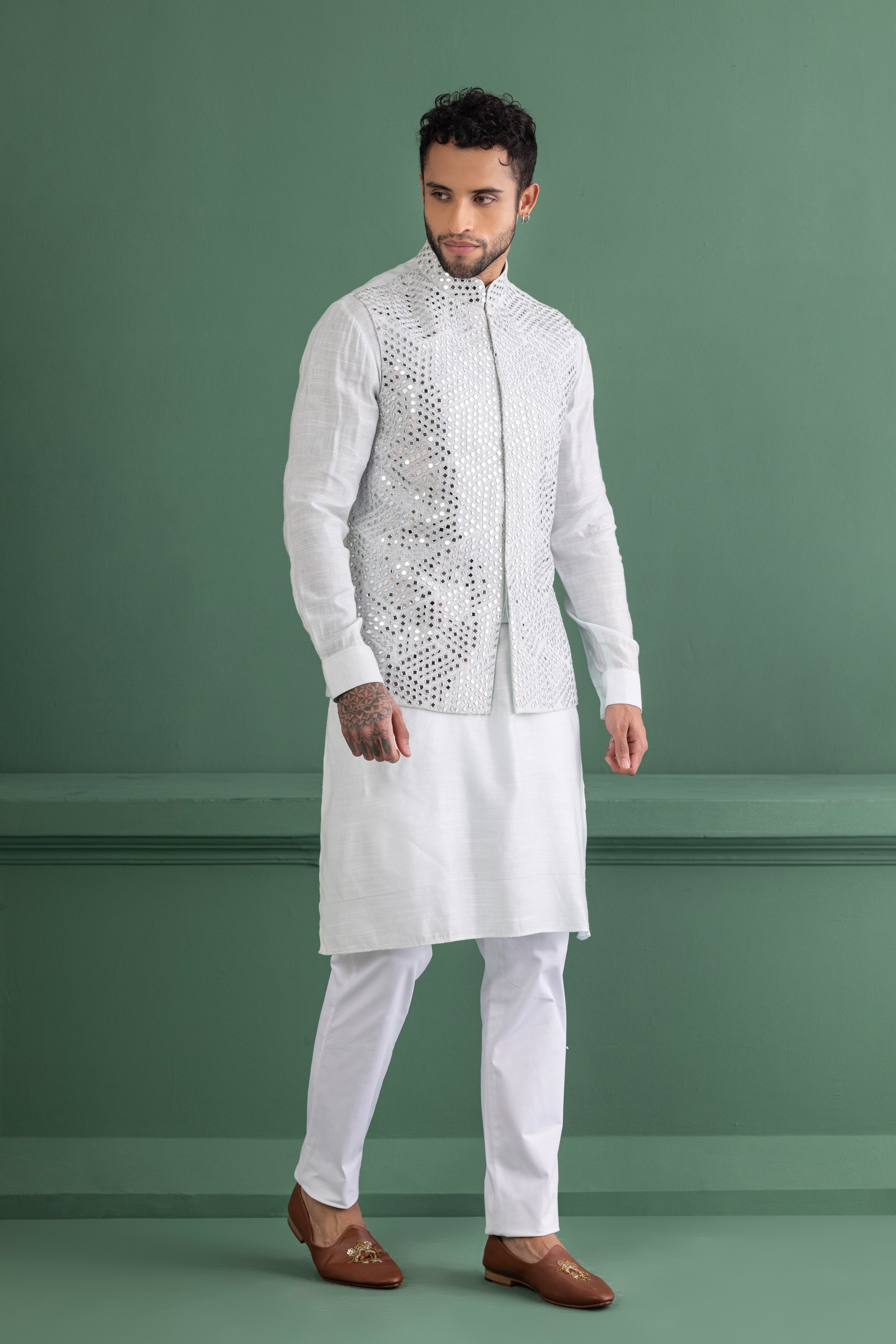 Teal mirror work waistcoat paired with a matching kurta and a white aligadhi