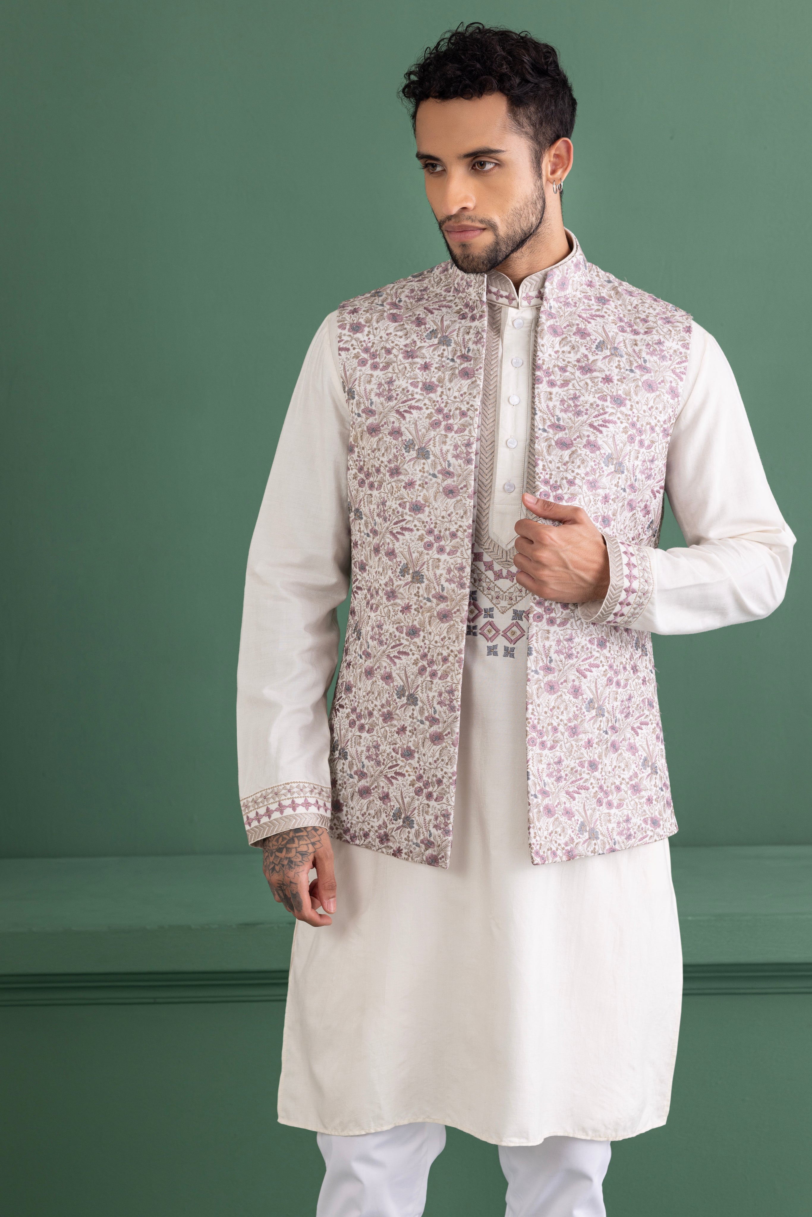 Purple waistcoat with floral embroidery paired with a matching kurta and off-white aligadhi