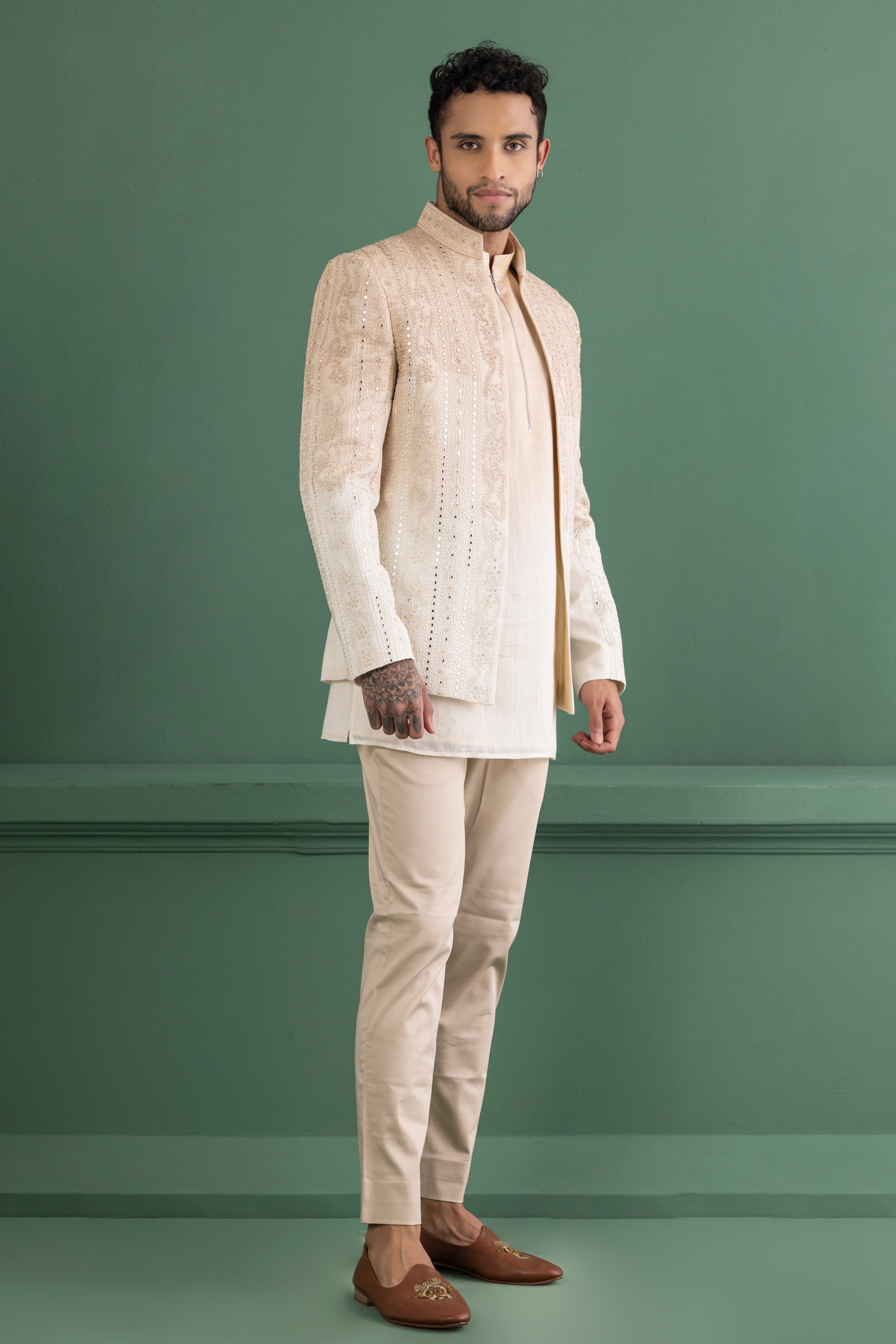 Biege shade open indowestern jacket with mirror work paired with a matching kurta and beige pants