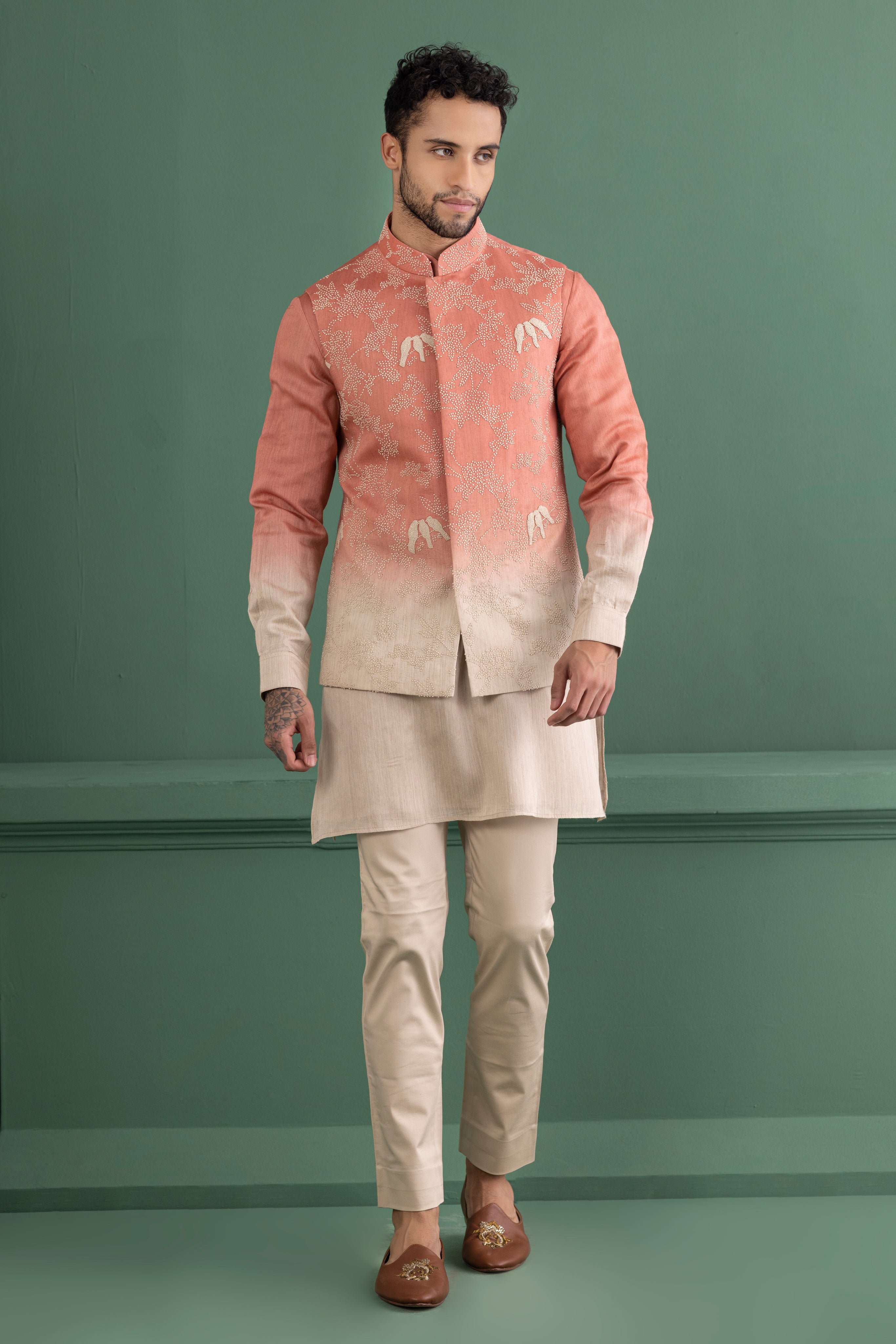 Pink shaded waistcoat with hand-embroidery paired with a matching kurta and beige Aligadhi