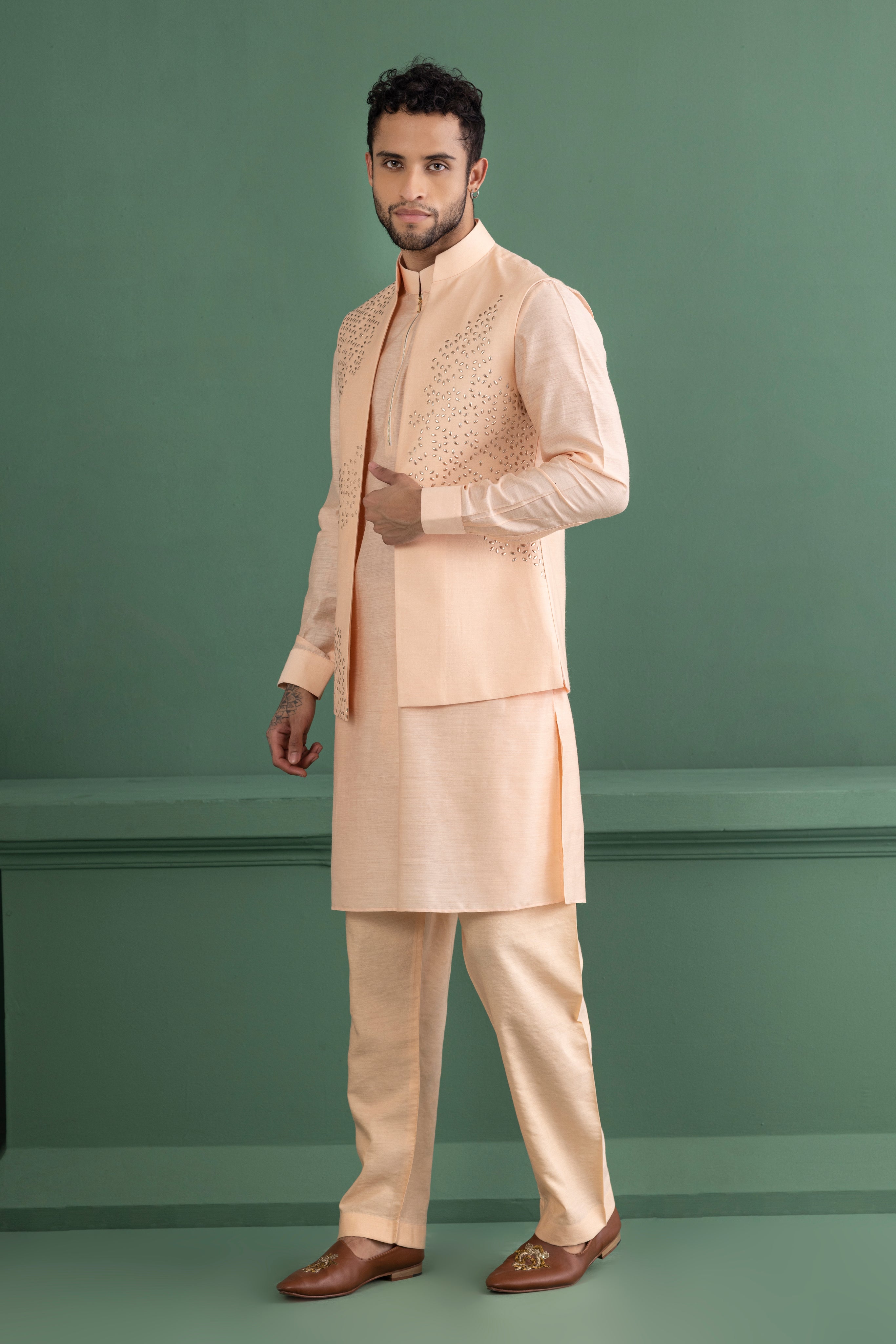 Peach waistcoat with metal wotk paired with matching kurta and aligadhi set