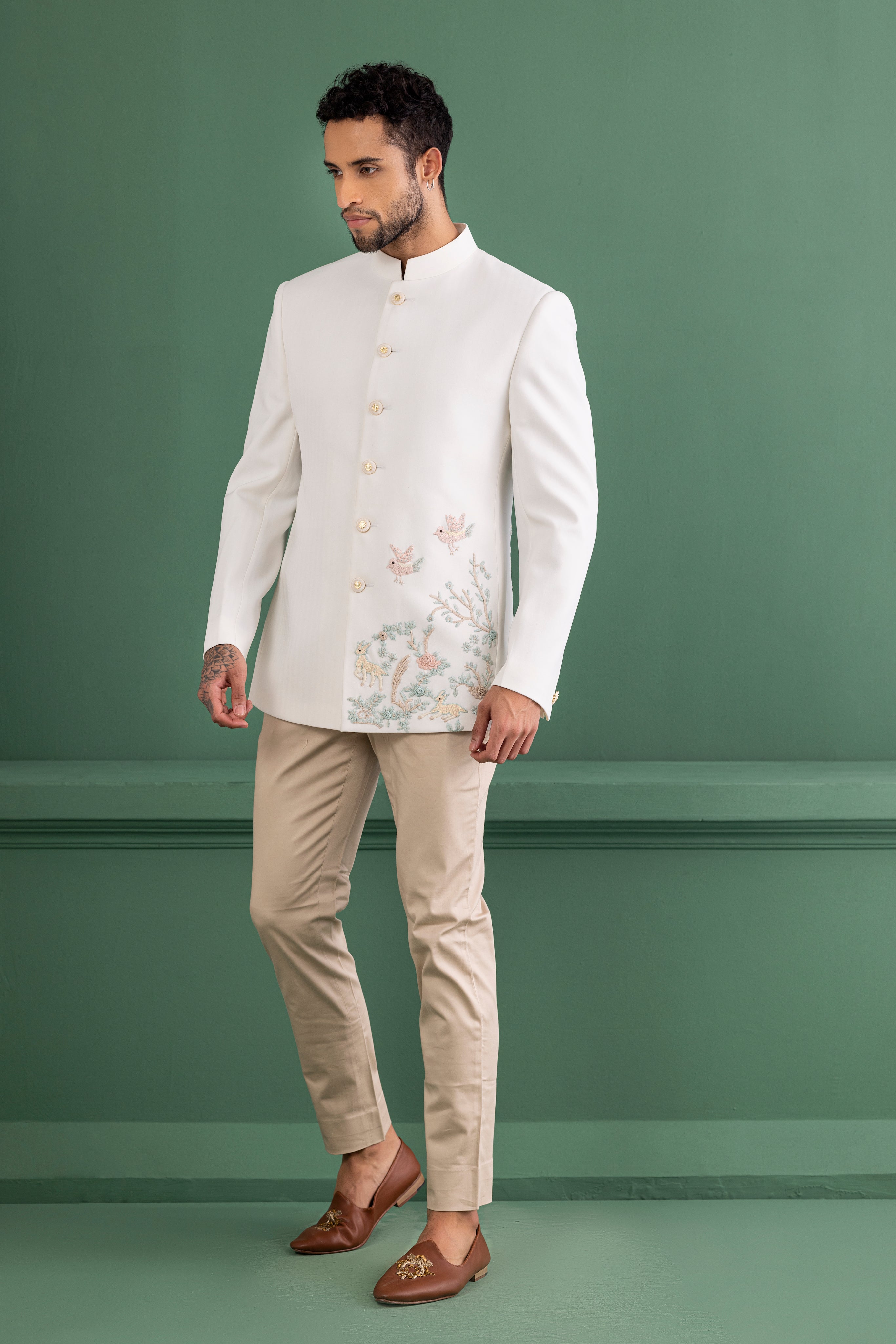 Ivory embroidered bandhgala paired with beige pants