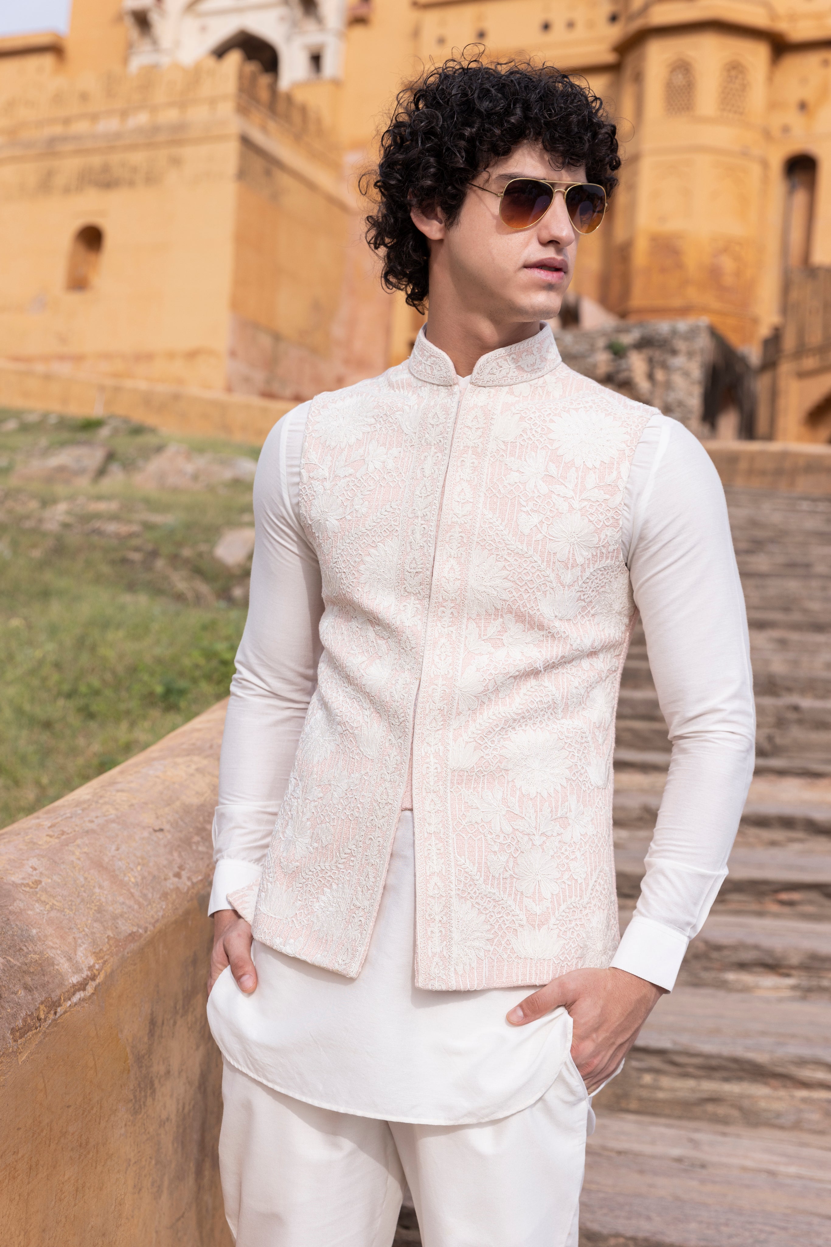 White kiran dori hand embroidery  waistcoat paired with kurta and aligadhi.