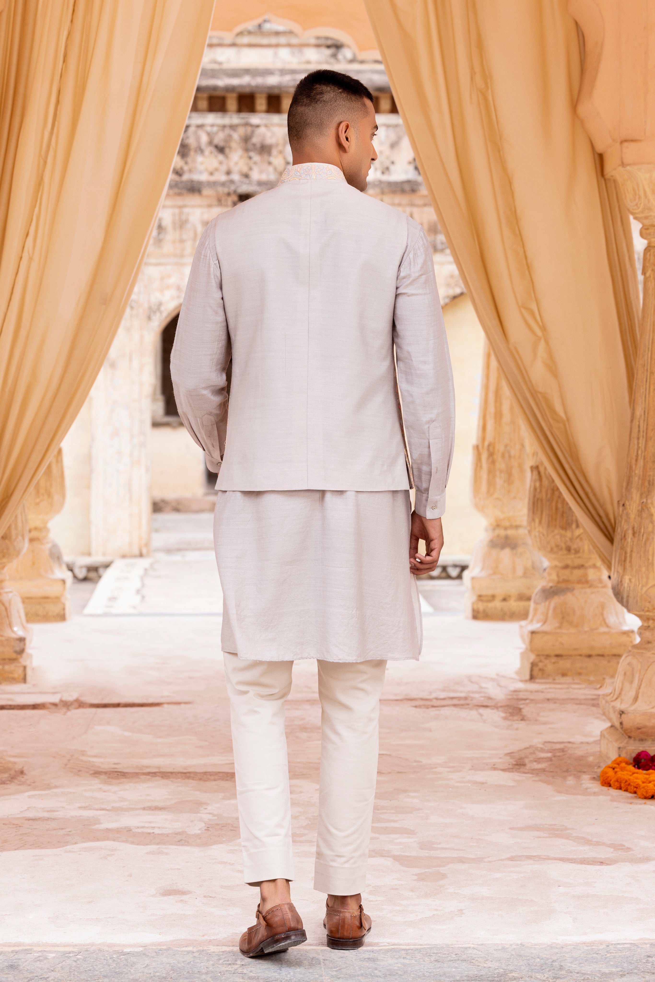 Kashmiri hand embroidery waistcoat paired with kurta and aligadhi.