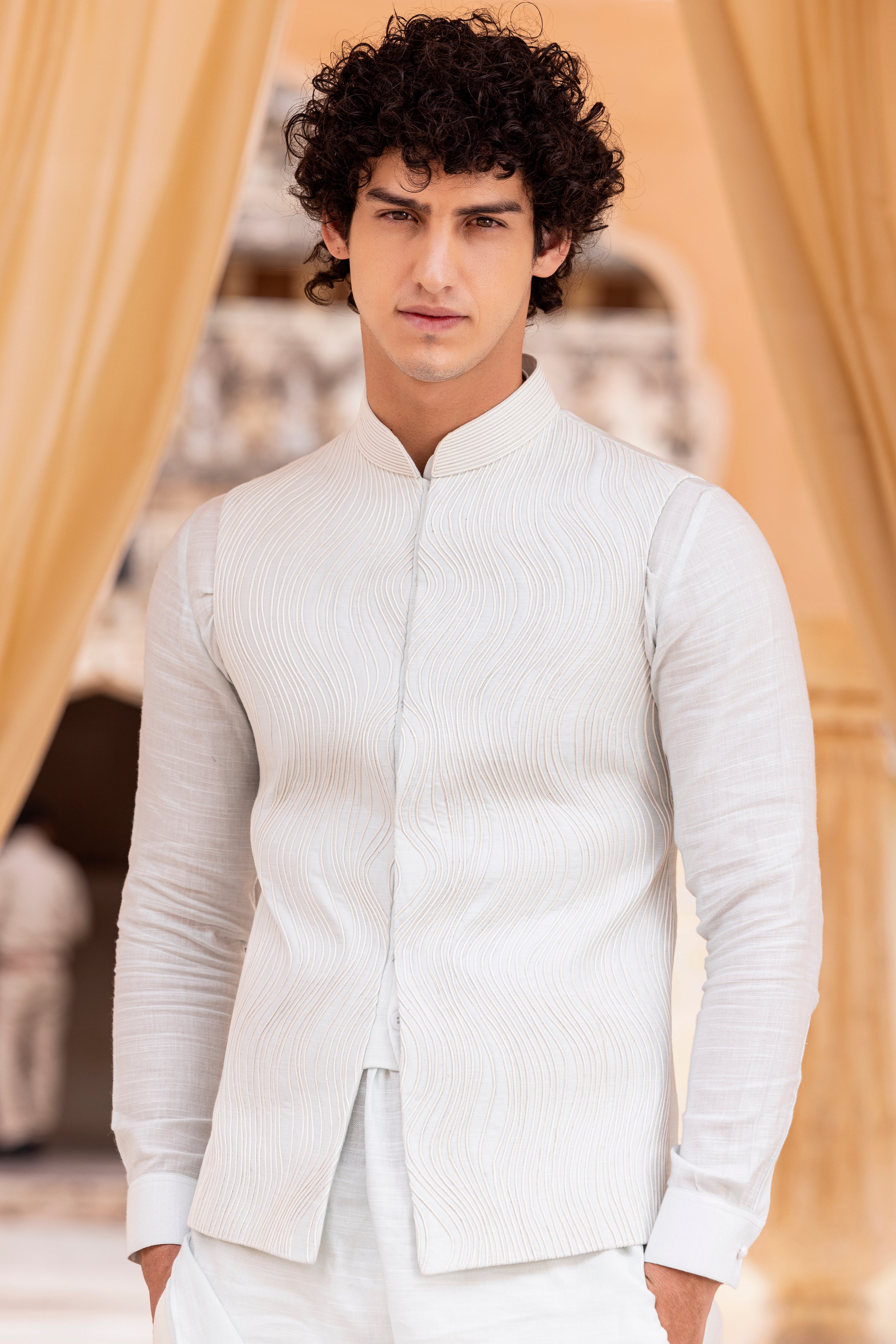 Leather work waistcoat paired with kurta and aligadhi.