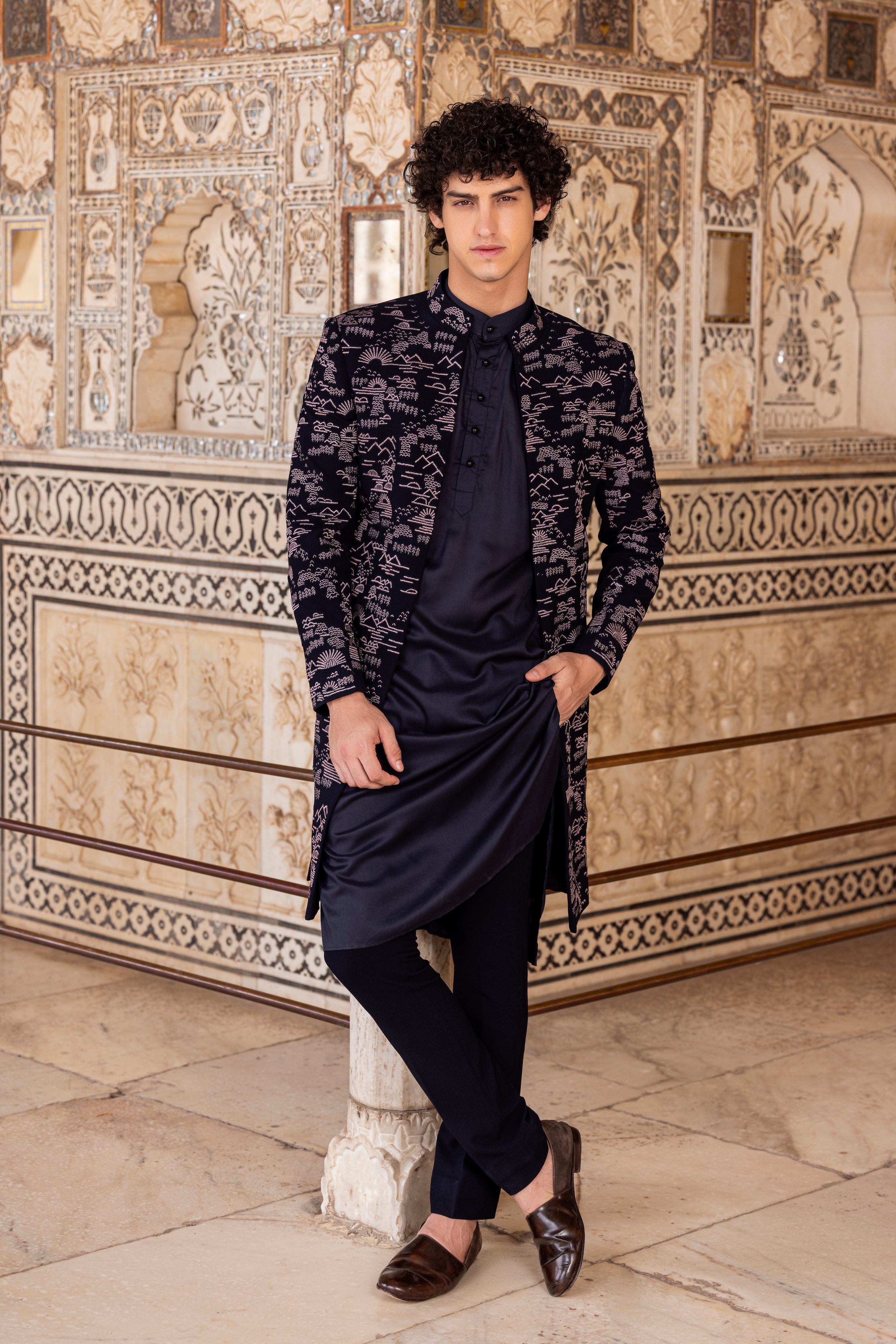 Navy Blue indowestern jacket with all over front embroidery paired with a kurta and pants.
