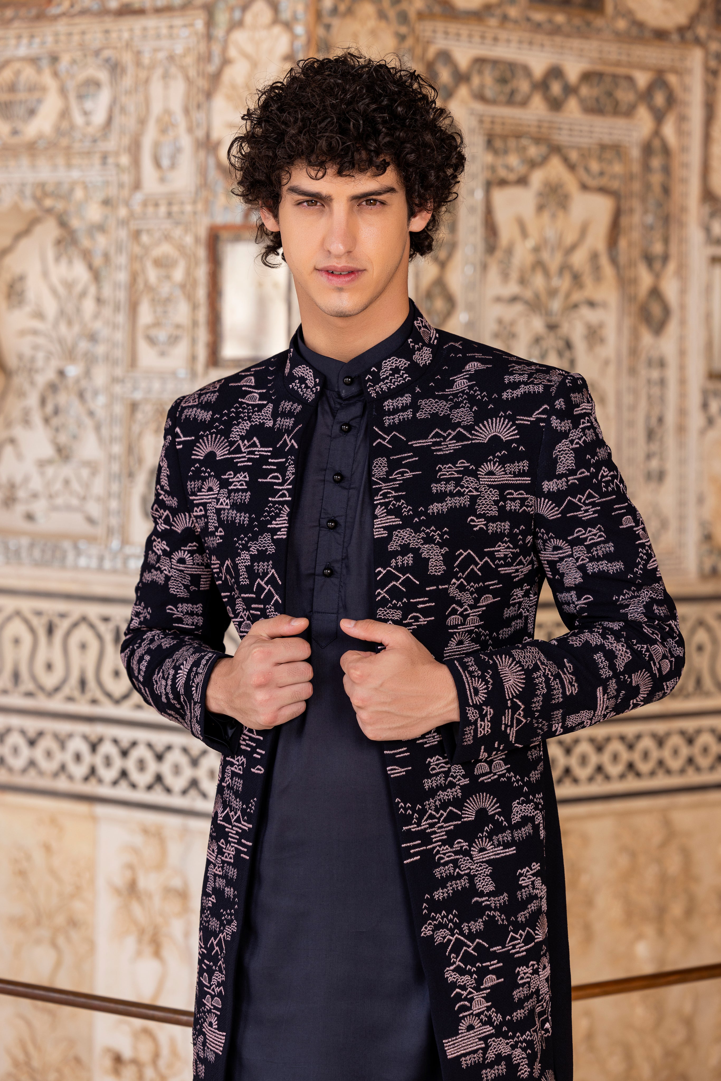 Navy Blue indowestern jacket with all over front embroidery paired with a kurta and pants.