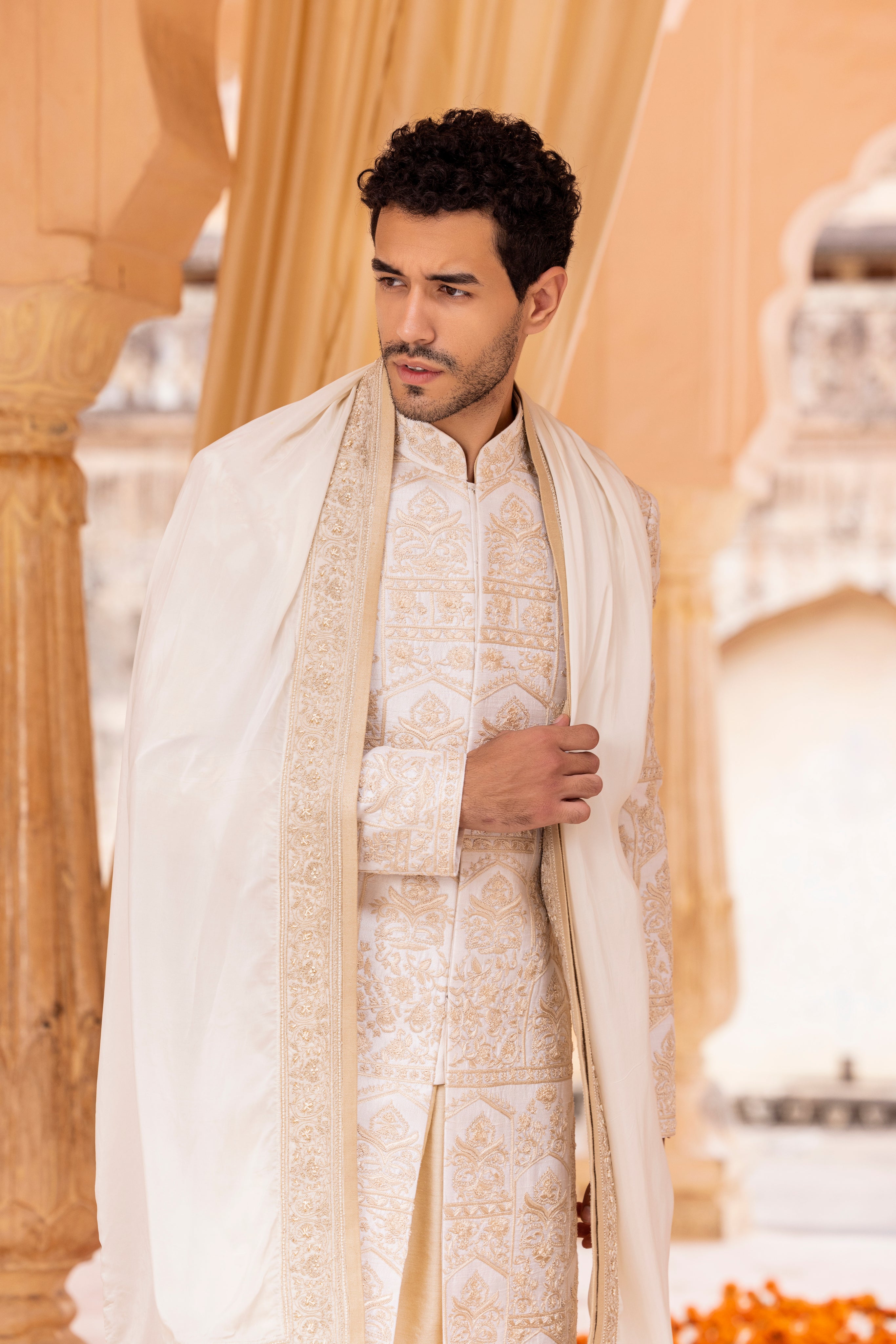 Hand embroidered sherwani paired with matching kurta, pyjama & stole.
