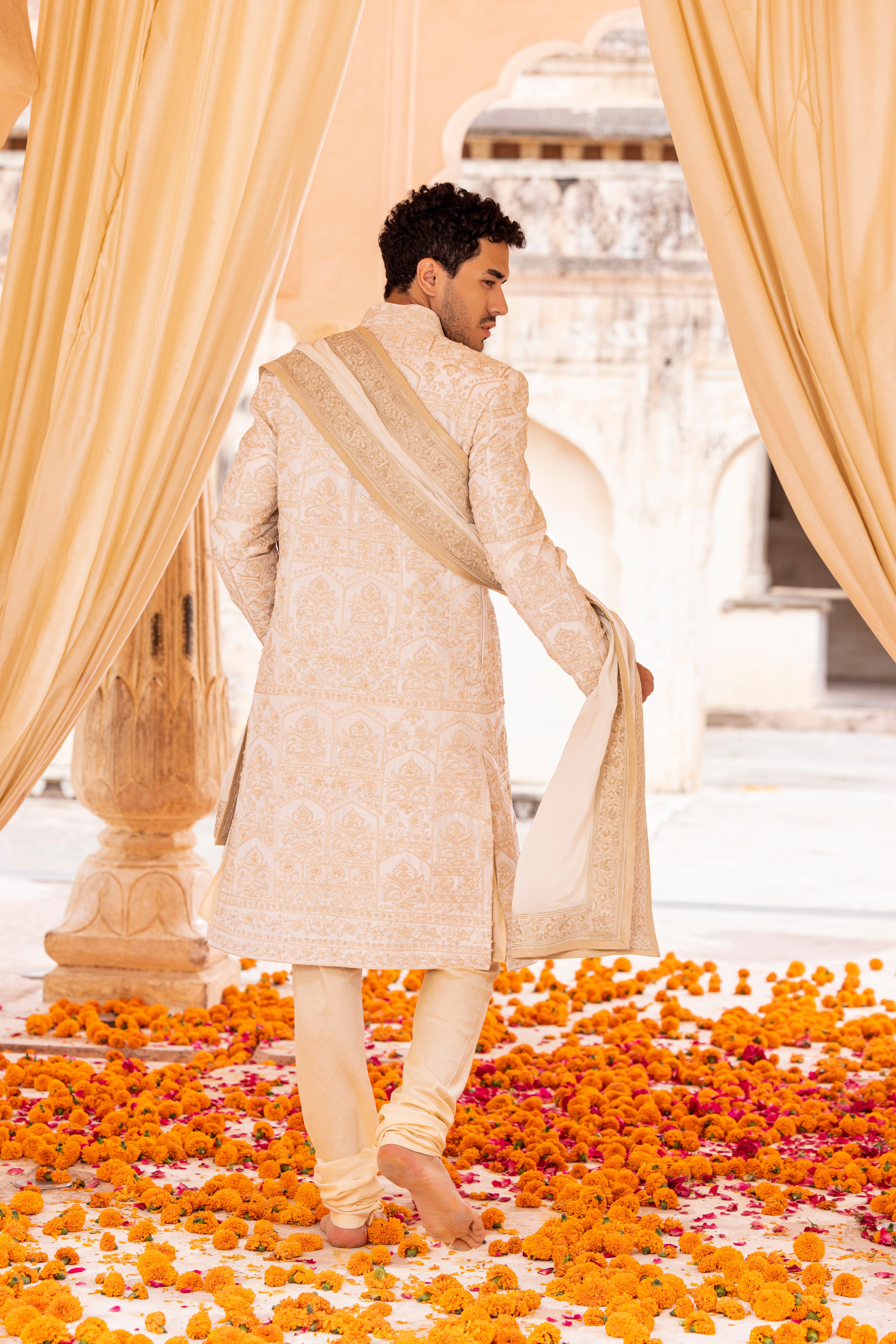 Hand embroidered sherwani paired with matching kurta, pyjama & stole.