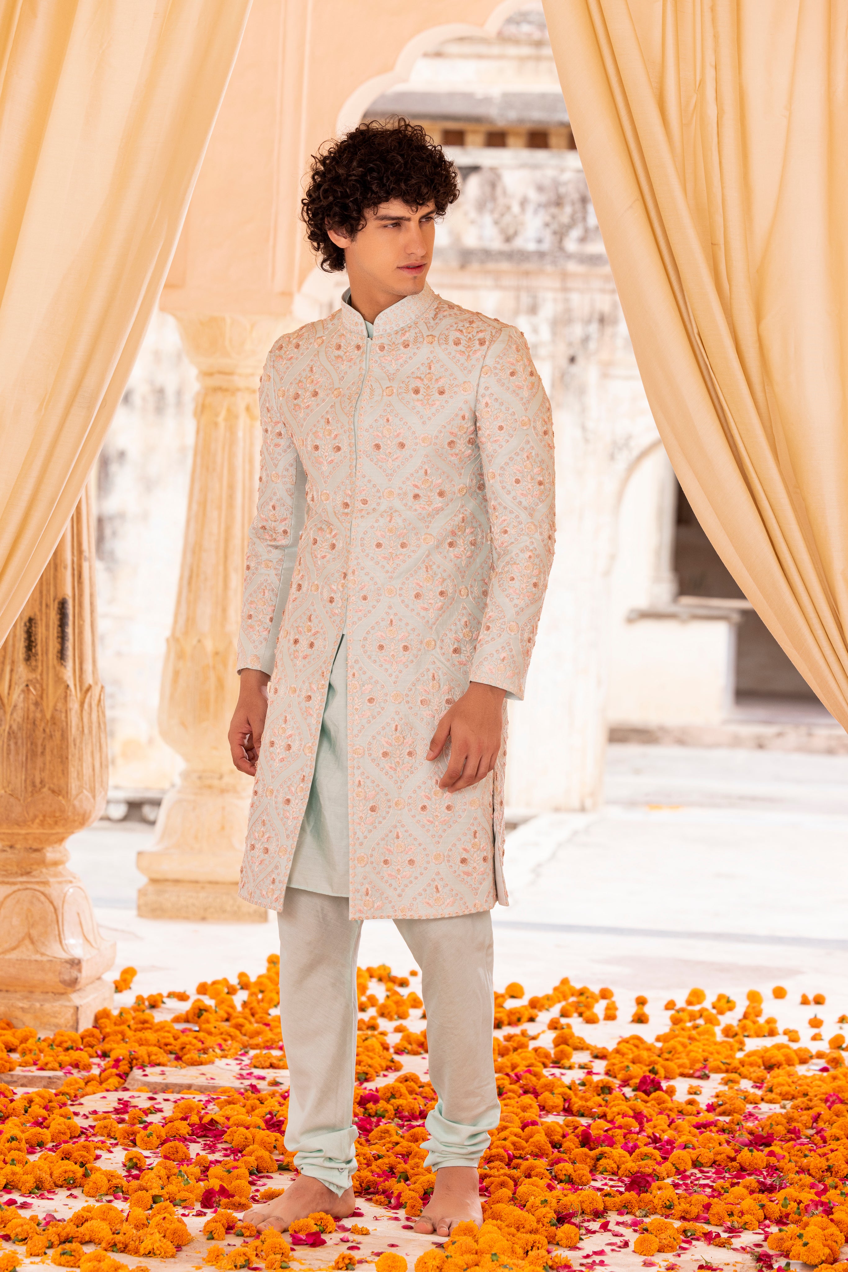 Hand embroidered sherwani paired with matching kurta, pyjama & stole.