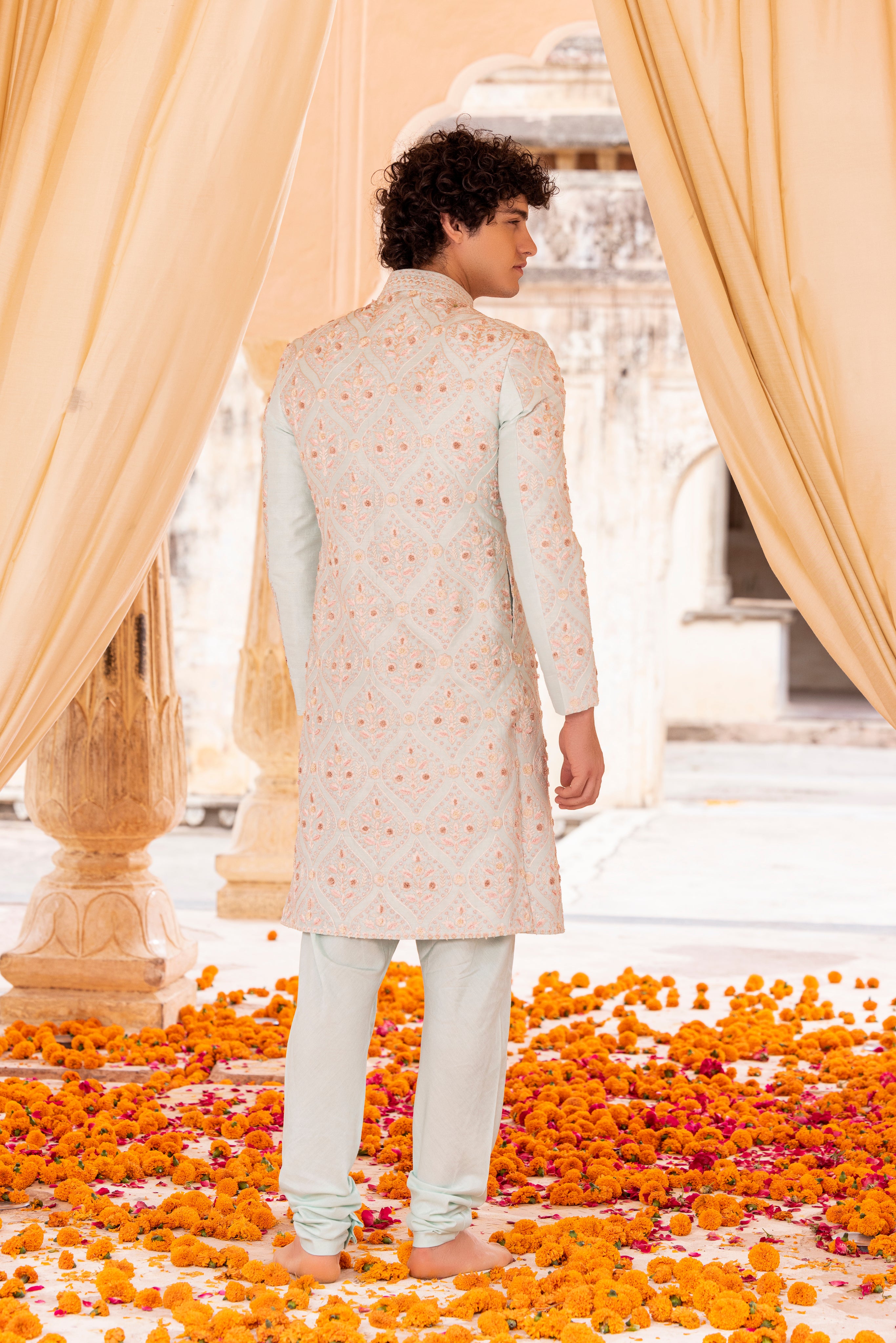 Hand embroidered sherwani paired with matching kurta, pyjama & stole.